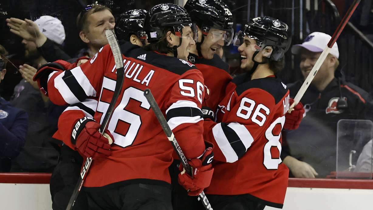 FILE - New Jersey Devils defenseman Damon Severson (28) celebrates with teammates after scoring a goal against the Edmonton Oilers during the second period of an NHL hockey game Monday, Nov. 21, 2022, in Newark, N.J. The New Jersey Devils cannot sneak up on teams anymore. The once-laughable also-rans have gone from a team that has missed the Stanley Cup playoffs nine of the last 10 years to currently the NHL's hottest team.