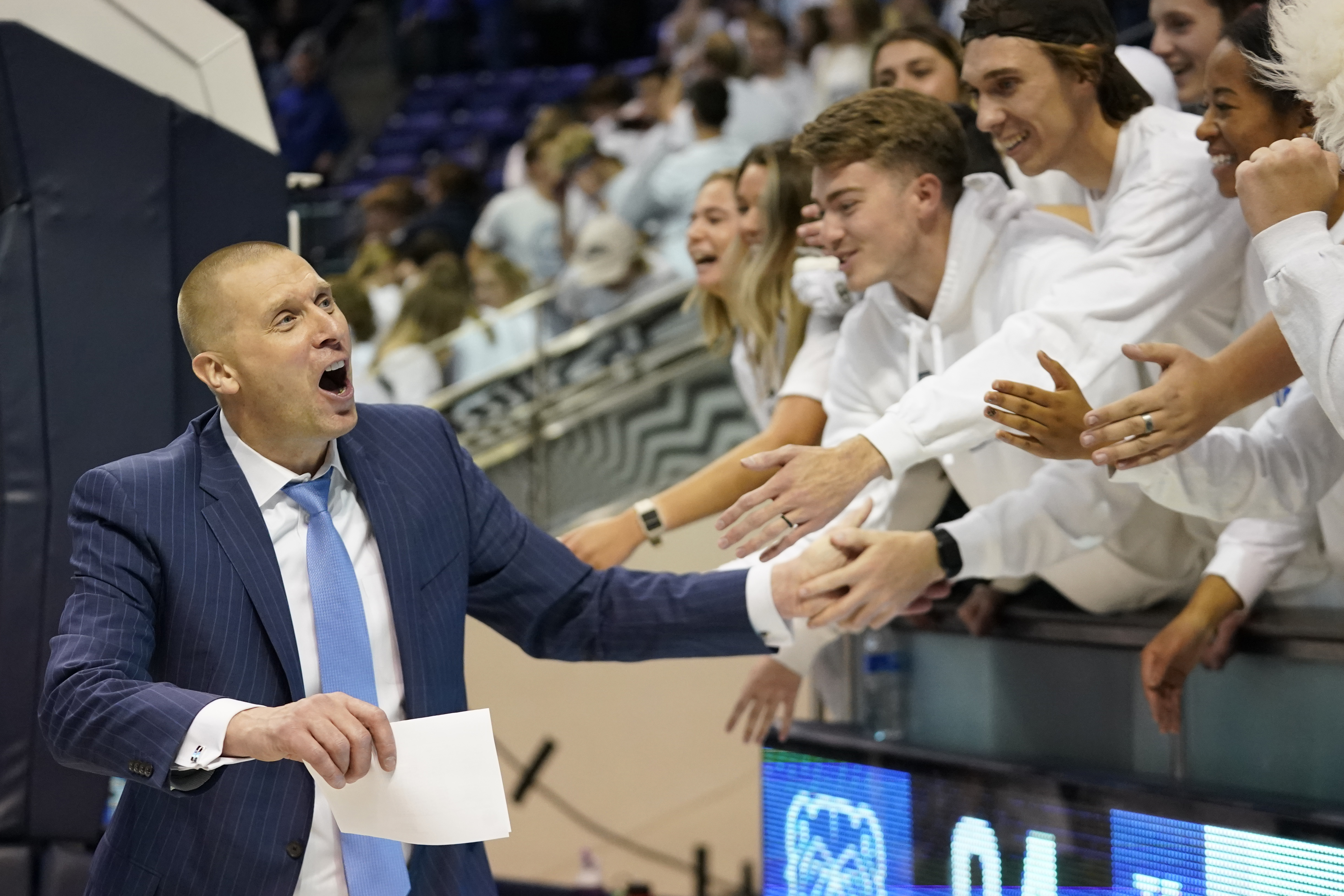 BYU coach Mark Pope celebrates with BYU students following the team's NCAA college basketball game against Missouri State on Wednesday, Nov. 16, 2022, in Provo, Utah.