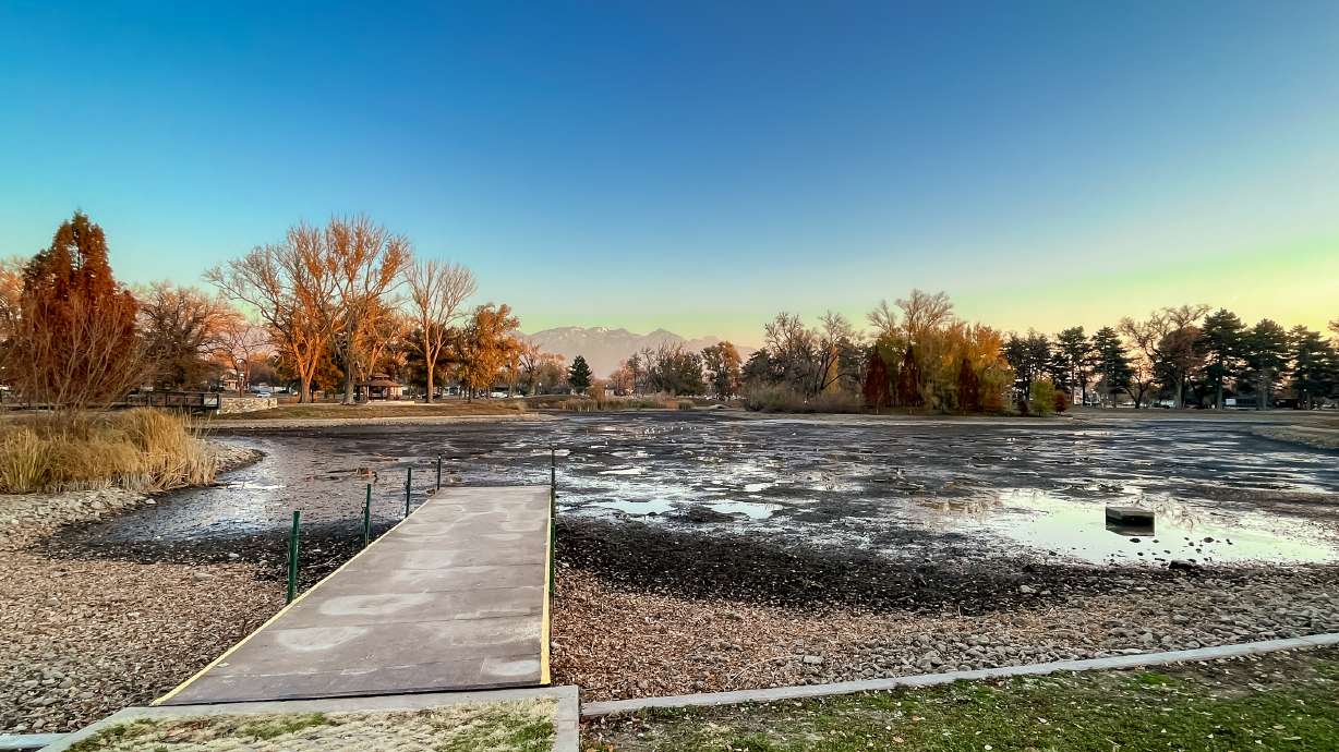 A view of Liberty Park's mostly empty pond on Tuesday afternoon. The pond will remain empty over the next few weeks while crews repair gates that regulate the pond's water levels.
