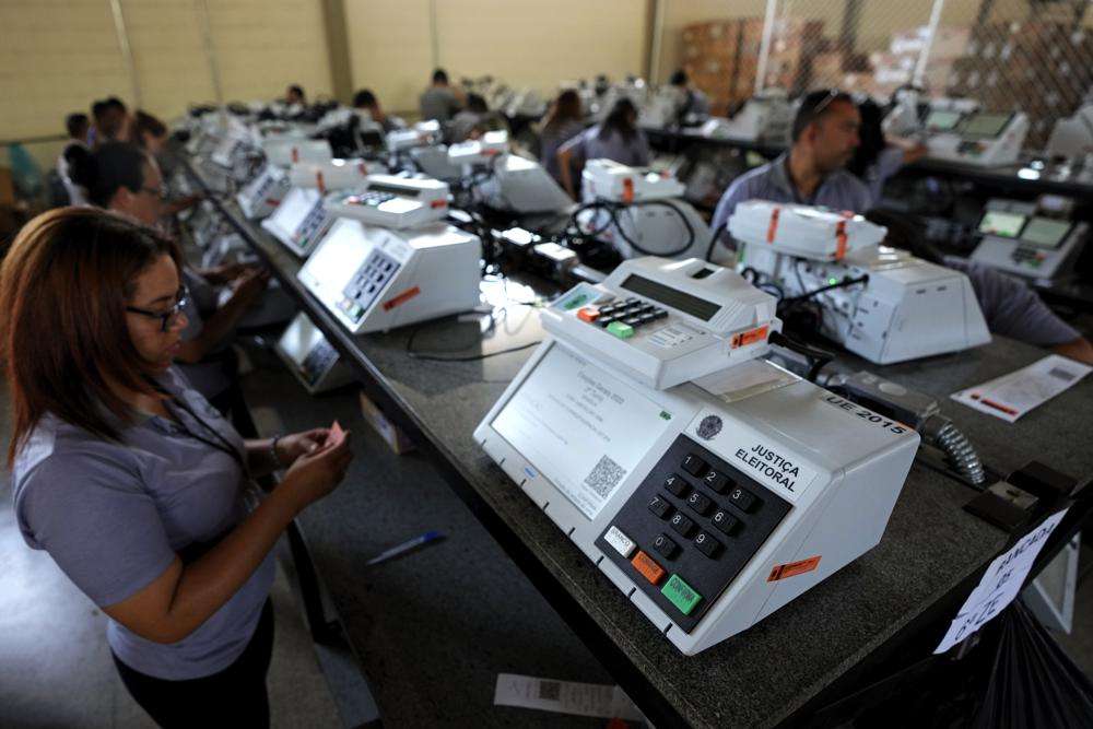 Electoral Court employees work on the final stage of sealing electronic voting machines in preparation for the general election run-off in Brasilia, Brazil, Oct. 19 ahead of the Oct. 30 second round vote. Valdemar Costa, president of the ruling Liberal Party, is calling on the electoral authority to annul votes cast on more than half of electronic voting machines used in the Oct. 30 election, citing a software bug.