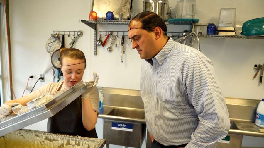 Baylee Sorenson, owner of Mountain Born Creamery, shows KSL’s Matt Gephardt how the butter is beginning to separate from the buttermilk.
