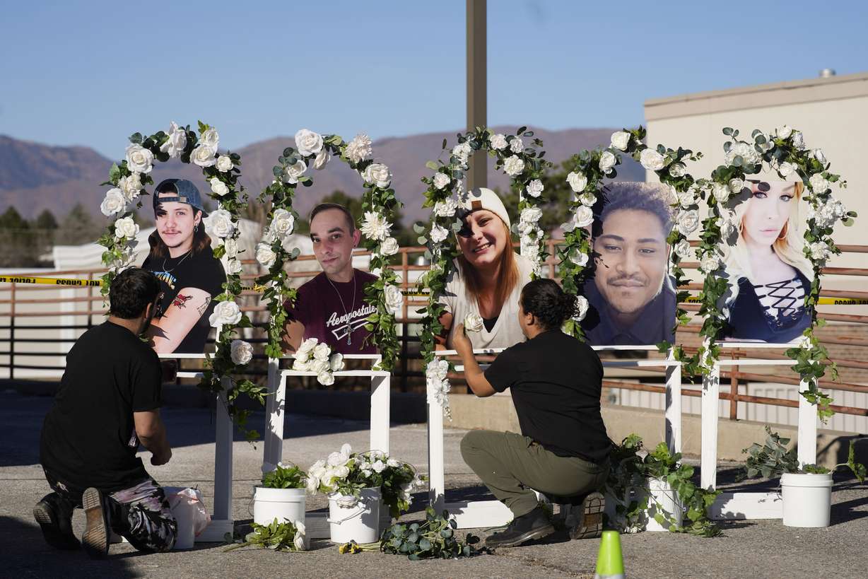 Noah Reich, left, and David Maldonado, the Los Angeles co-founders of Classroom of Compassion, put up a memorial with photographs of the five victims of a weekend mass shooting at a nearby gay nightclub on Tuesday in Colorado Springs, Colo.