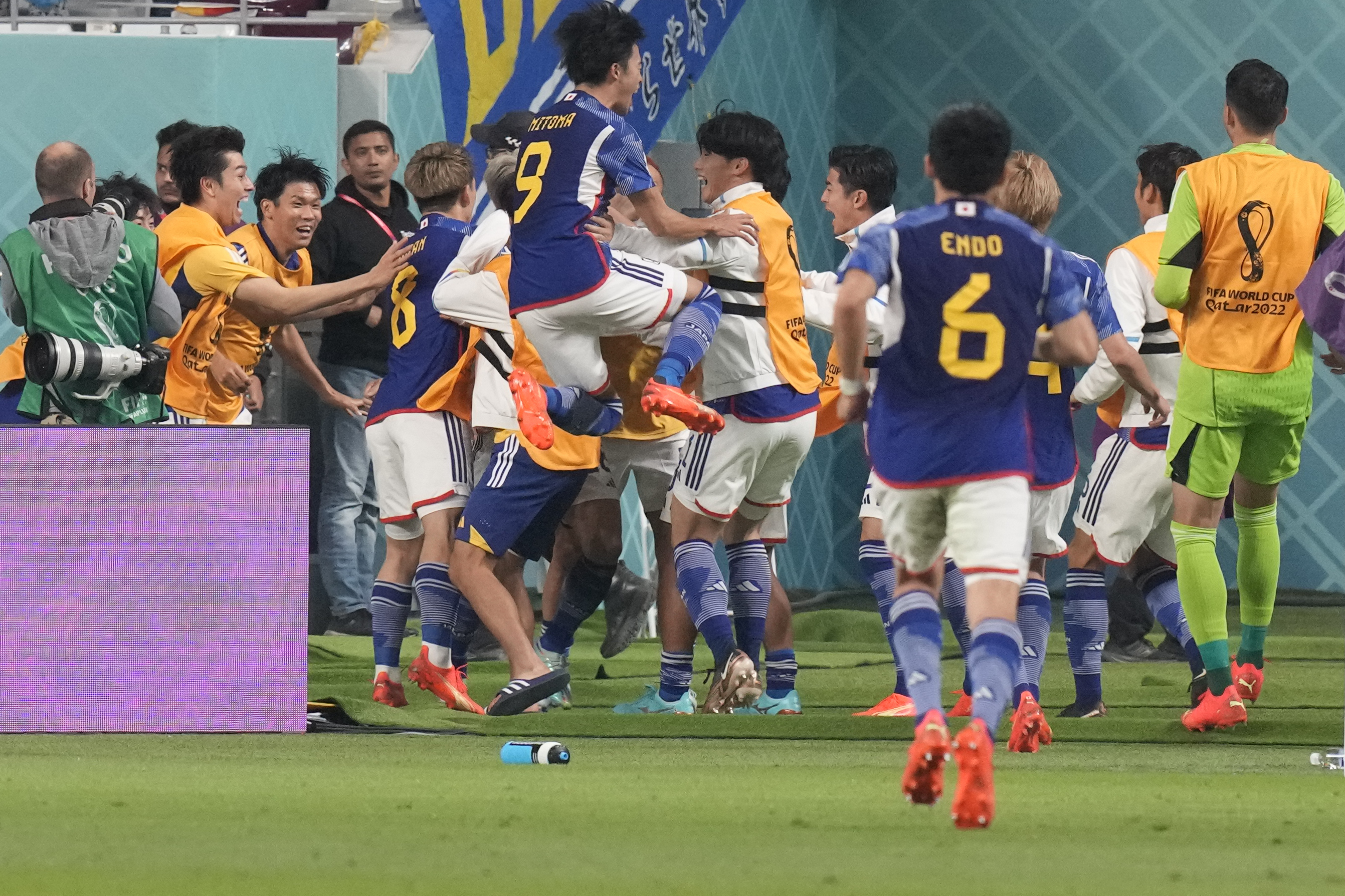 Japan players celebrate after Takuma Asano scored his side's second goal during the World Cup group E soccer match between Germany and Japan, at the Khalifa International Stadium in Doha, Qatar, Wednesday, Nov. 23, 2022.