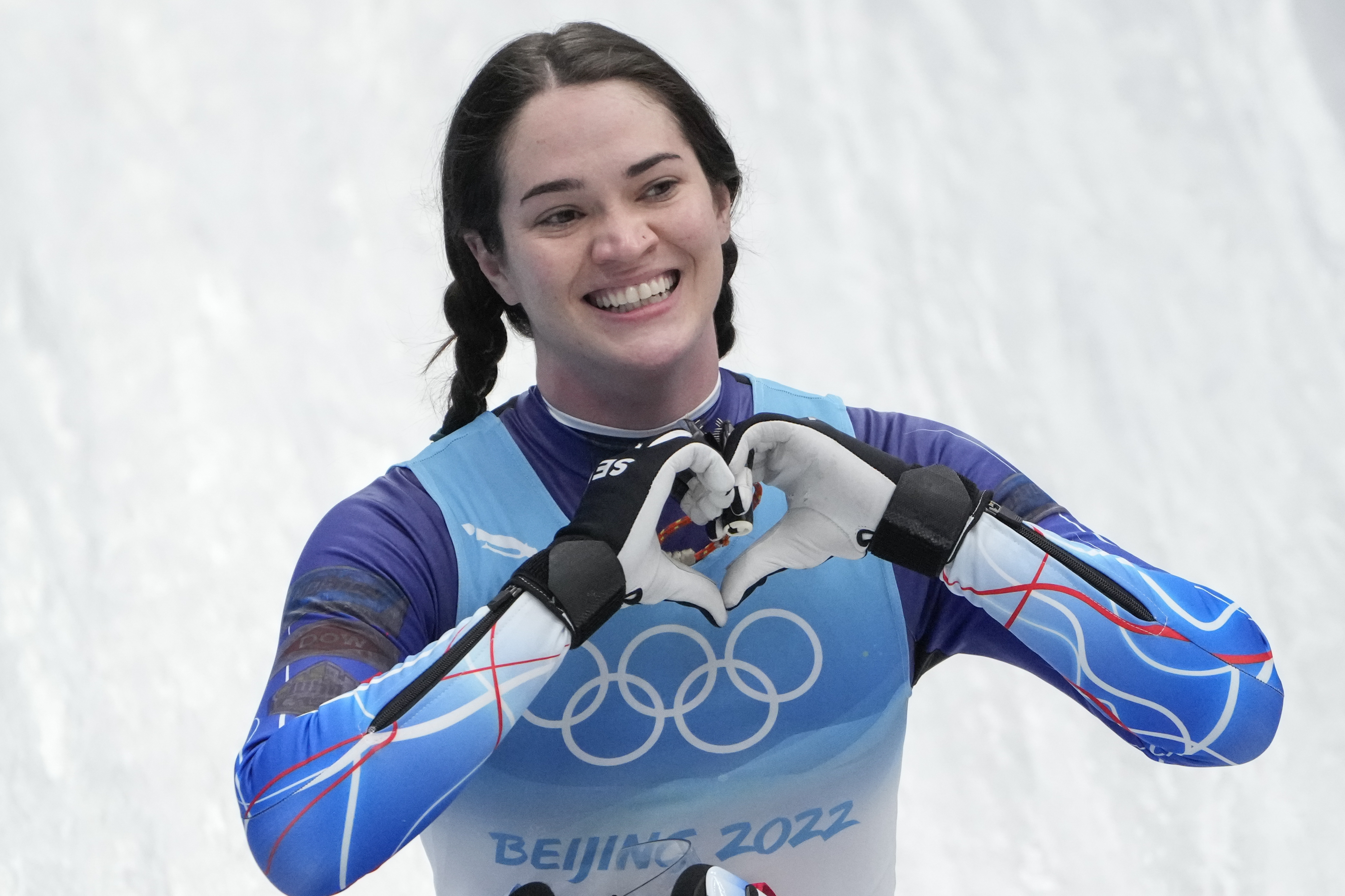FILE - Summer Britcher, of the United States, finishes the luge women's singles run 3 at the 2022 Winter Olympics, Tuesday, Feb. 8, 2022, in the Yanqing district of Beijing. Summer Britcher and Emily Sweeney have been USA Luge teammates for years. They’ve traveled together, they’ve competed together, they’ve gone to the Olympics together, they’ve stood on World Cup podiums together. Being on a sled together was not part of the plan.