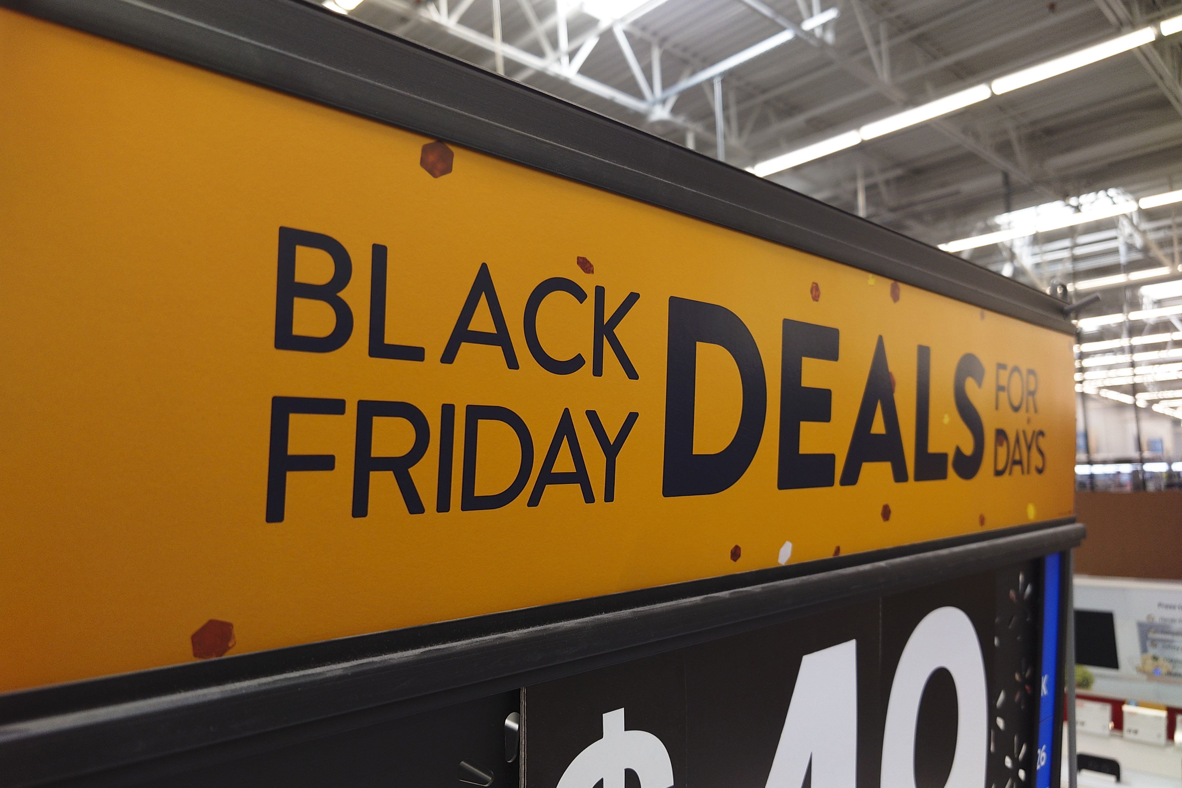 A "Black Friday" sign is posted at a retail location in Philadelphia, Monday. Bargain hunting is back with full force heading into the holidays. But inflation is limiting how much of a deal consumers will be getting.