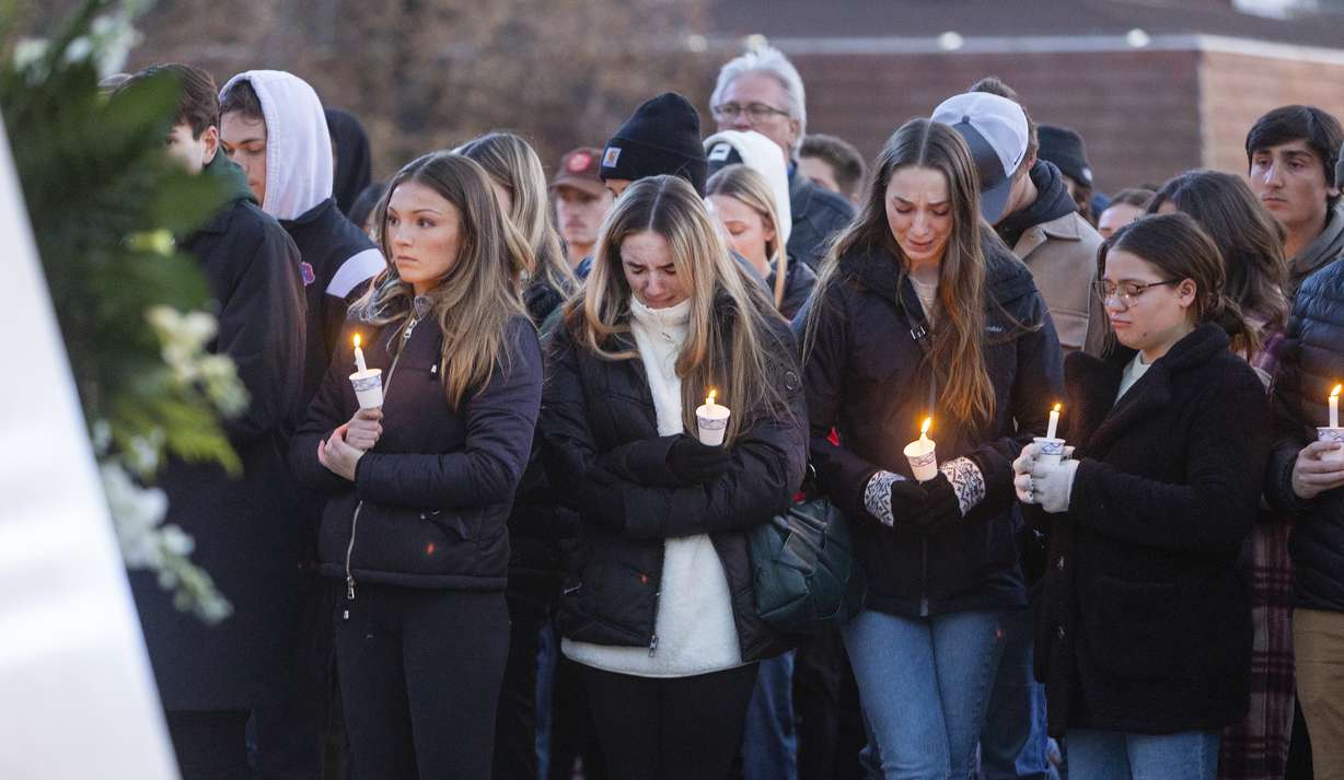 Boise State University students, along with people who knew the four University of Idaho students who were found killed in Moscow, Idaho, days earlier, pay their respects at a vigil held in front of a statue on the Boise State campus, Thursday, Nov. 17, in Boise, Idaho. Autopsies performed on the four students who were found dead inside a rental house near campus showed that all four were stabbed to death, the Latah County coroner said.