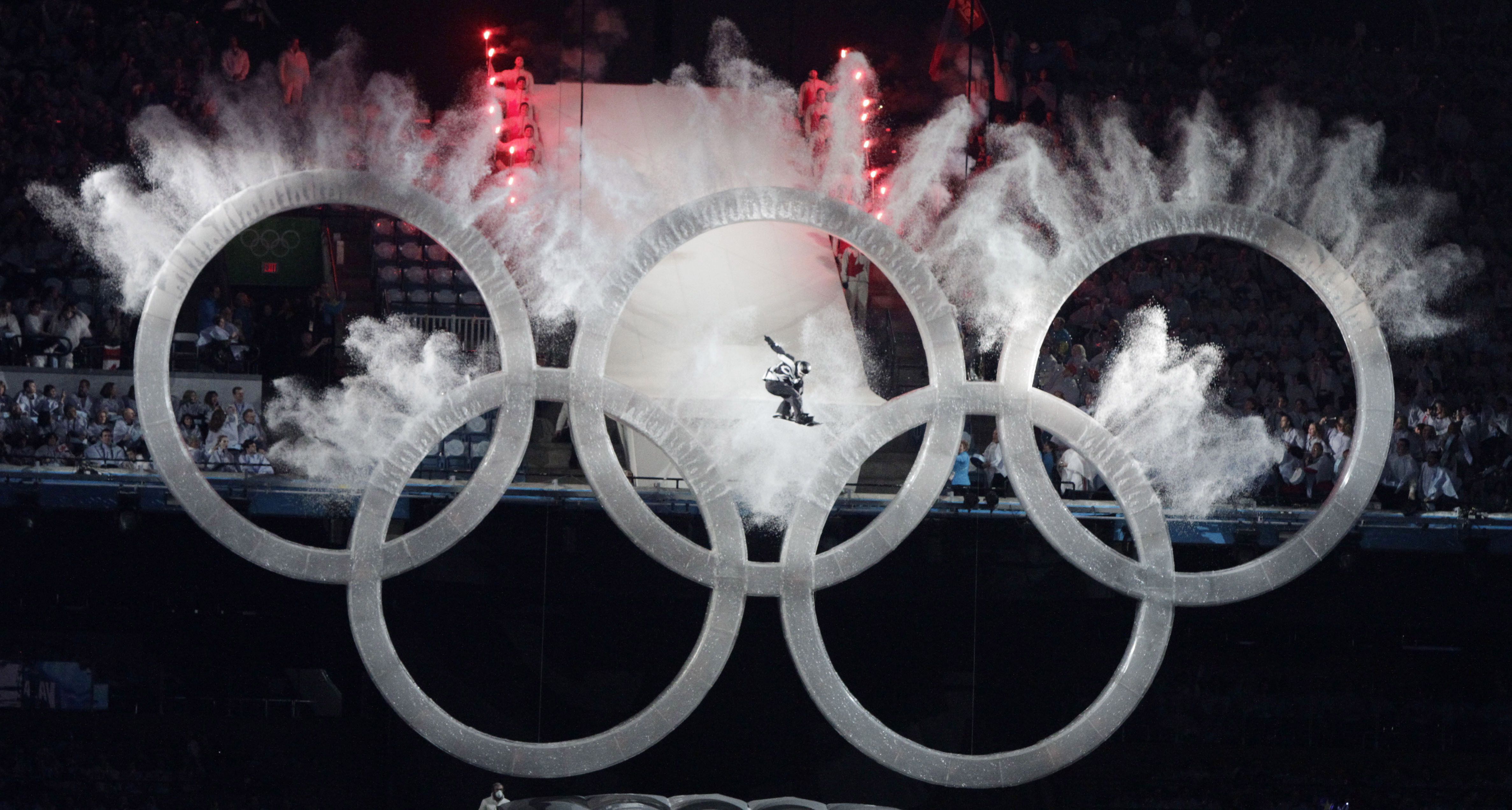 A snowboarder sails through the Olympic rings during the opening ceremony for the Vancouver 2010 Olympics in Vancouver, British Columbia, on Feb. 12, 2010.