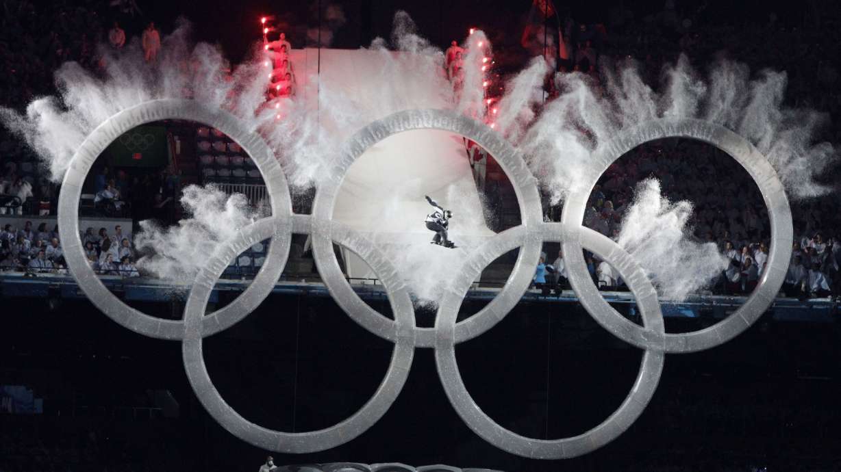 A snowboarder sails through the Olympic rings during the opening ceremony for the Vancouver 2010 Olympics in Vancouver, British Columbia, on Feb. 12, 2010.