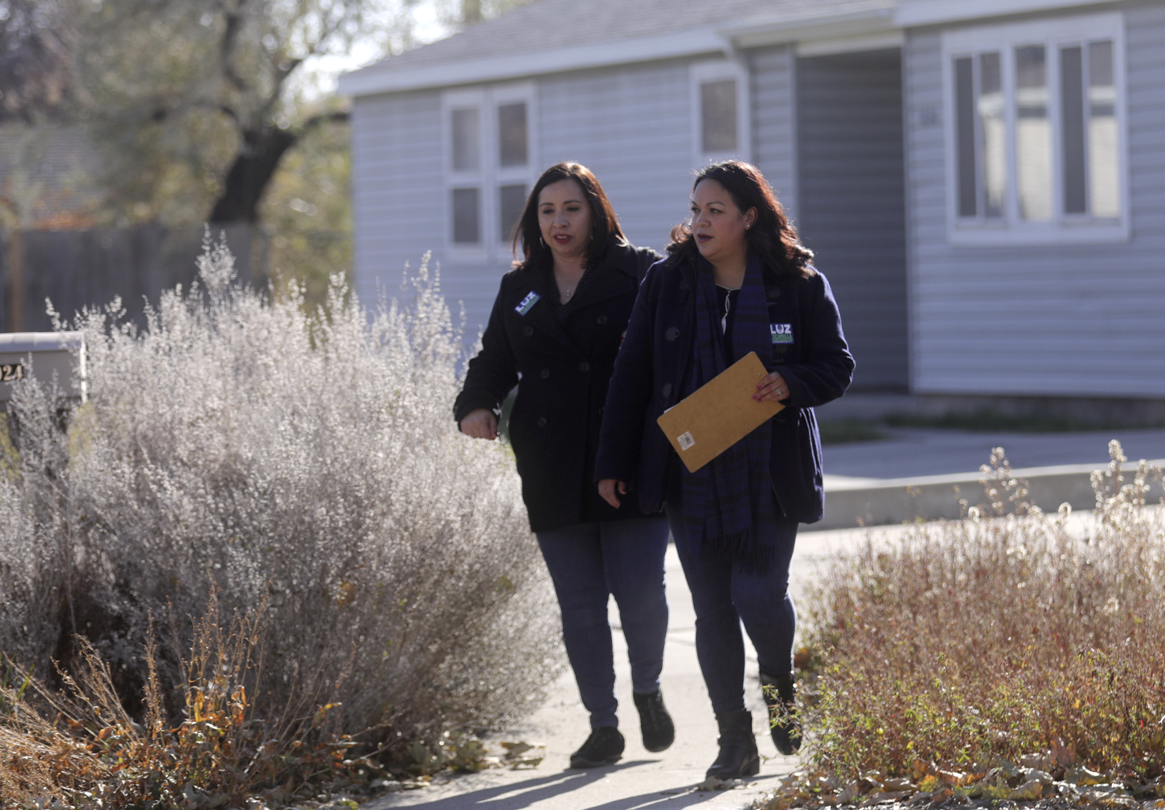 Rep. Angela Romero and Sen. Luz Escamilla walk together campaigning for Escamilla's mayoral run in the Glendale neighborhood in Salt Lake City on Nov. 1, 2019. The two women were recently elected as minority leaders in the Utah House and Senate.