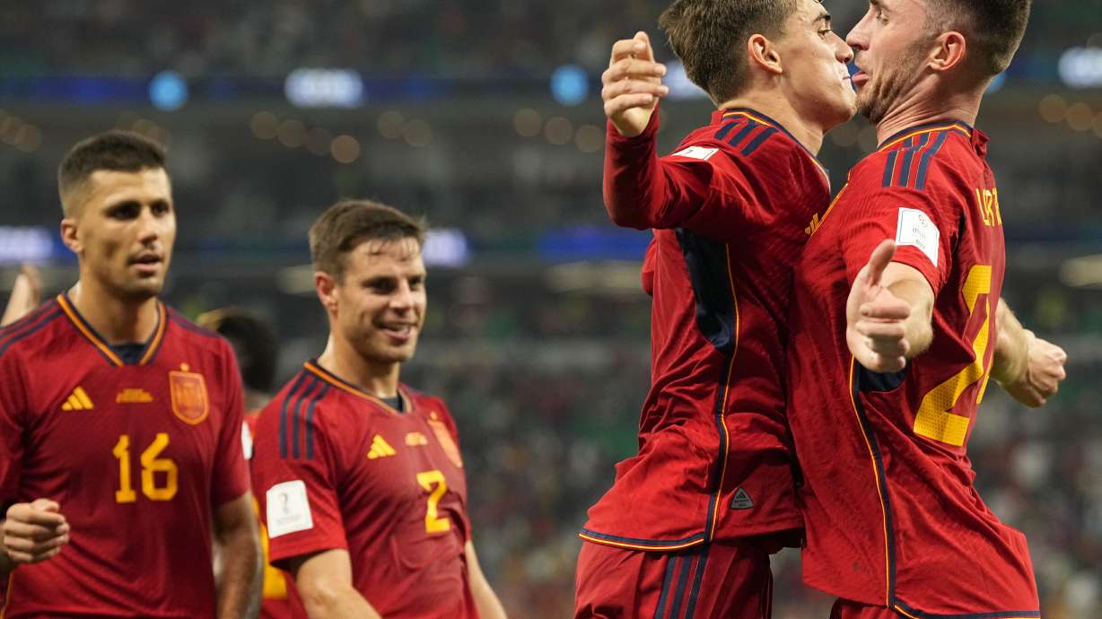 Spain's Gavi, second right, celebrates with Aymeric Laporte after scoring his side's fifth goal during the World Cup group E soccer match between Spain and Costa Rica, at the Al Thumama Stadium in Doha, Qatar, Wednesday, Nov. 23, 2022.