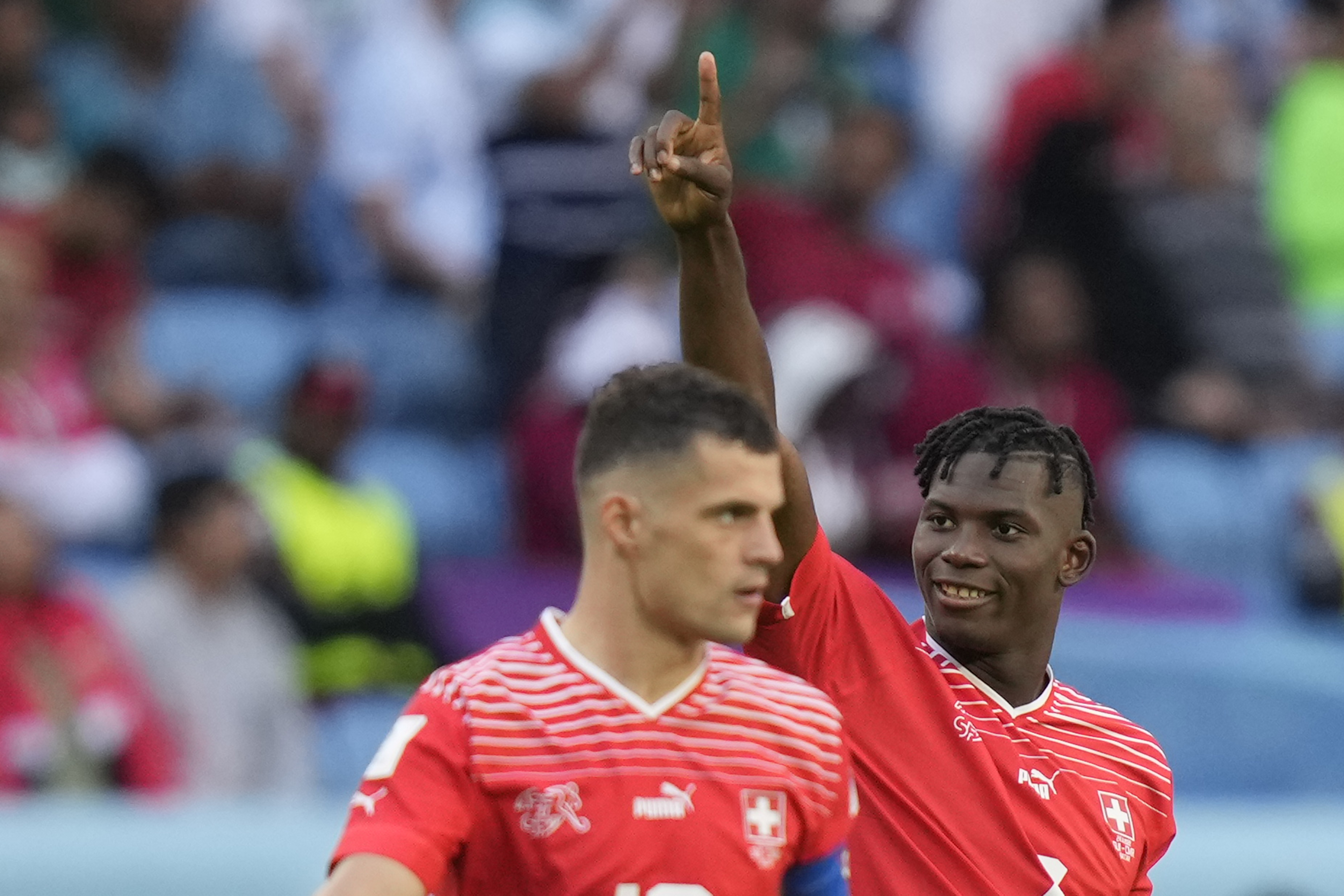 Switzerland's Breel Embolo, right, celebrates after scoring his side's opening goal during the World Cup group G soccer match between Switzerland and Cameroon, at the Al Janoub Stadium in Al Wakrah, Qatar, Thursday, Nov. 24, 2022. 