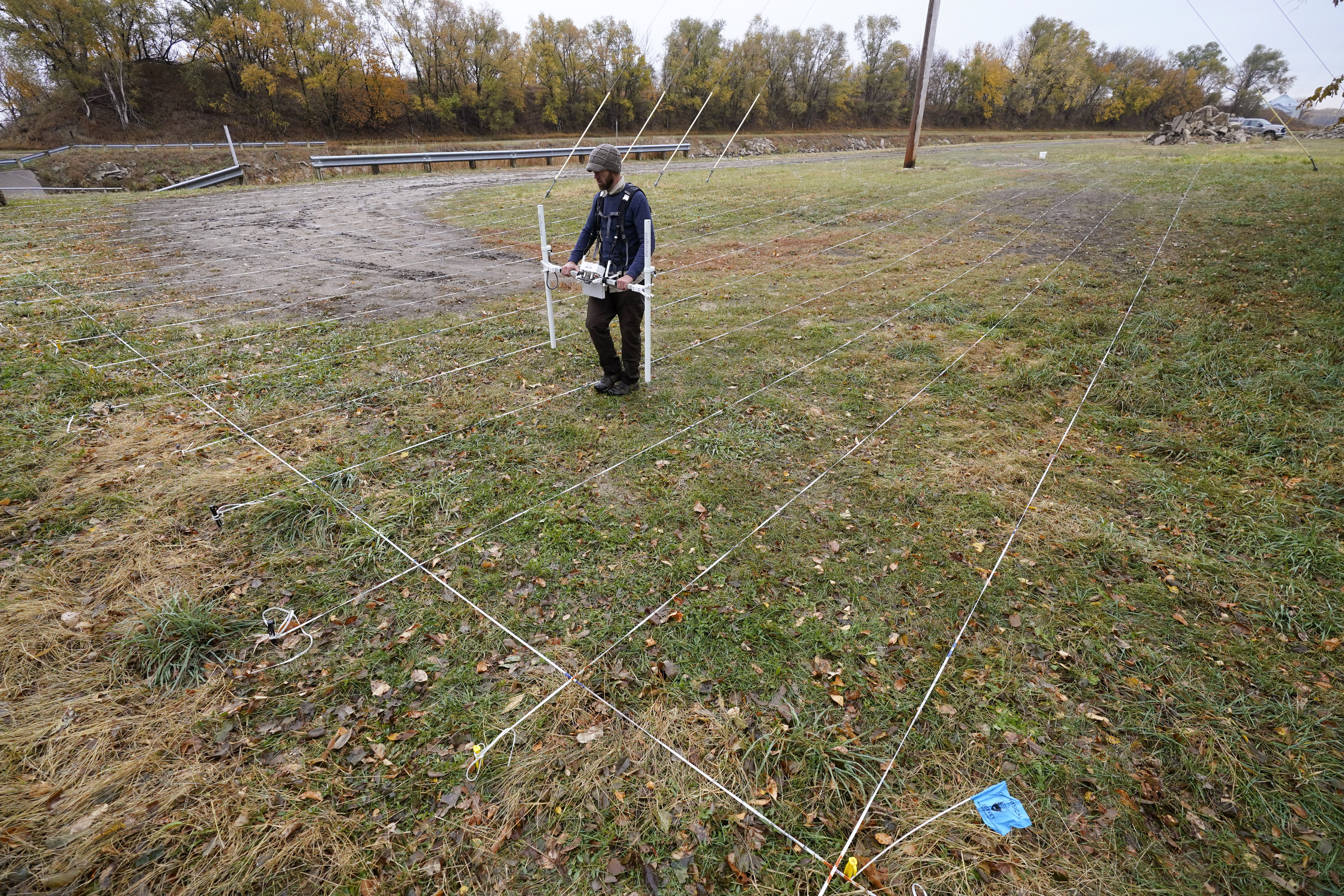 A member of a team affiliated with the National Park Service uses ground-penetrating radar in hopes of detecting what is beneath the soil while searching for over 80 Native American children buried at the former Genoa Indian Industrial School, Thursday, in Genoa, Neb. For decades the location of the student cemetery has been a mystery, lost over time after the school closed in 1931 and memories faded of the once-busy campus that sprawled over 640 acres in the tiny community of Genoa.