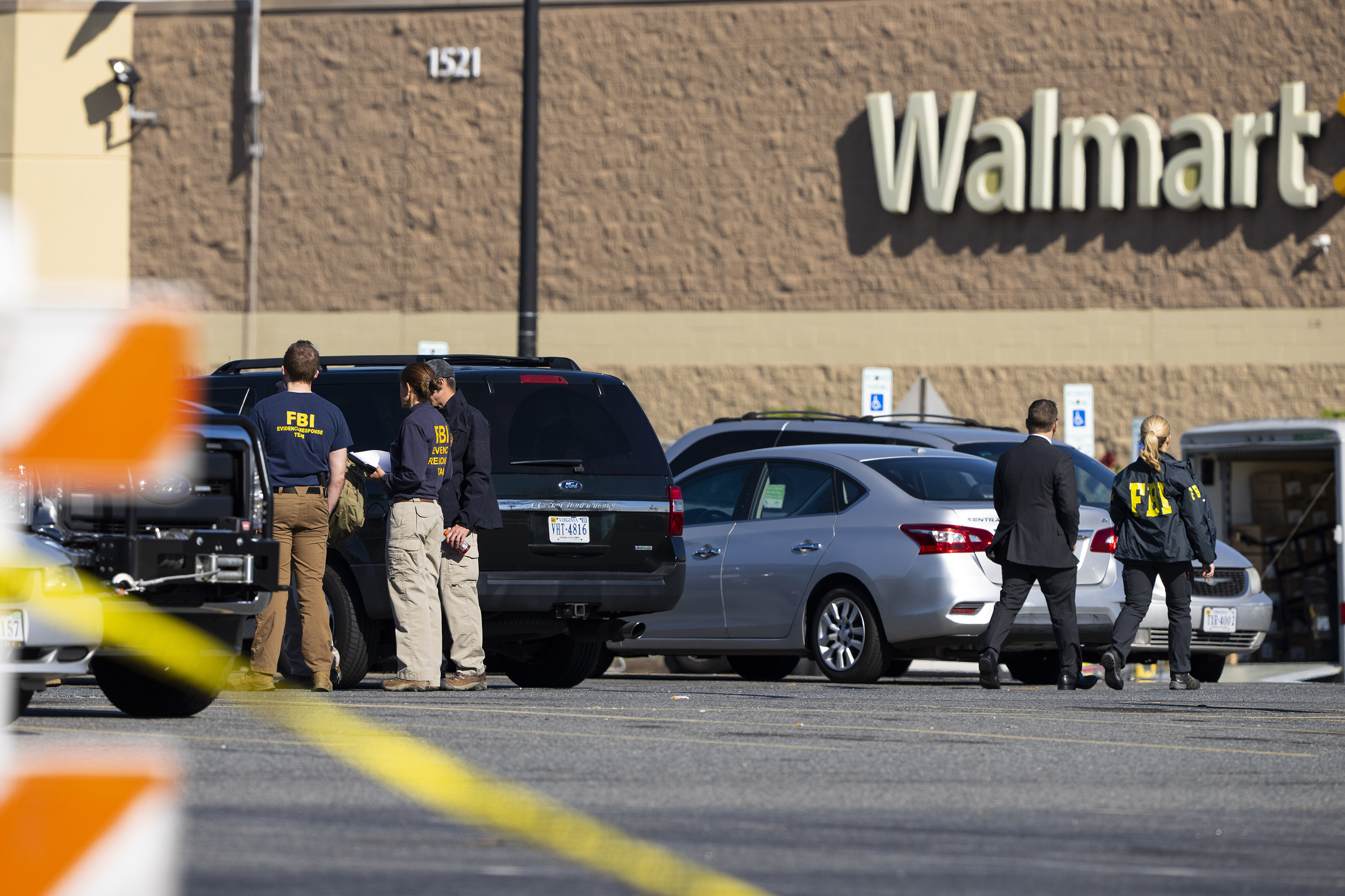 Law enforcement, including the FBI, work at the scene of a mass shooting at a Walmart, Wednesday, in Chesapeake, Va. A Walmart manager opened fire on fellow employees in the break room of the Virginia store, killing several people in the country’s second high-profile mass shooting in four days, police and witnesses said Wednesday.