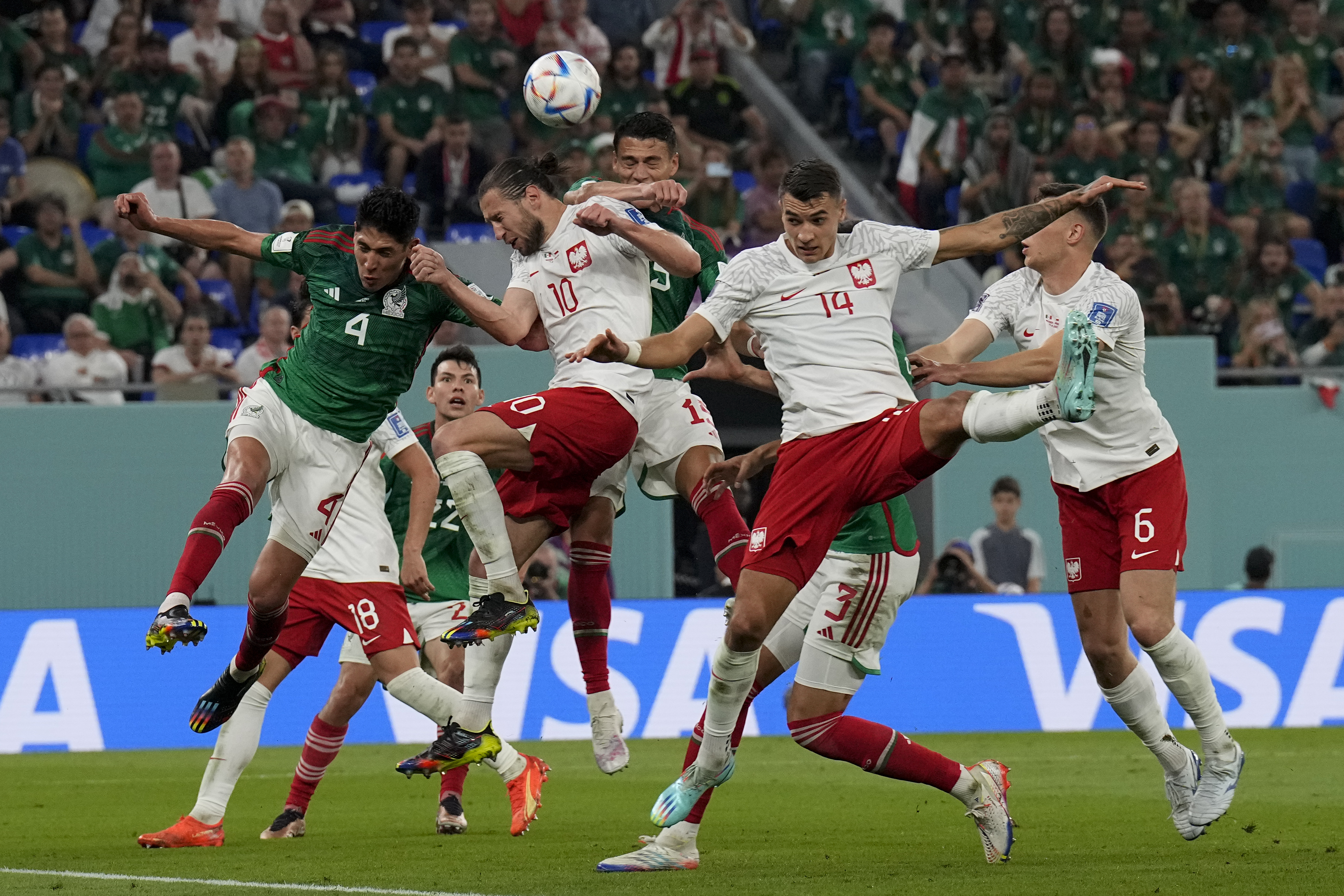 Poland's Grzegorz Krychowiak (10) and Mexico's Edson Alvarez go for a header during a World Cup group C soccer match at the Stadium 974 in Doha, Qatar, Tuesday, Nov. 22, 2022. 