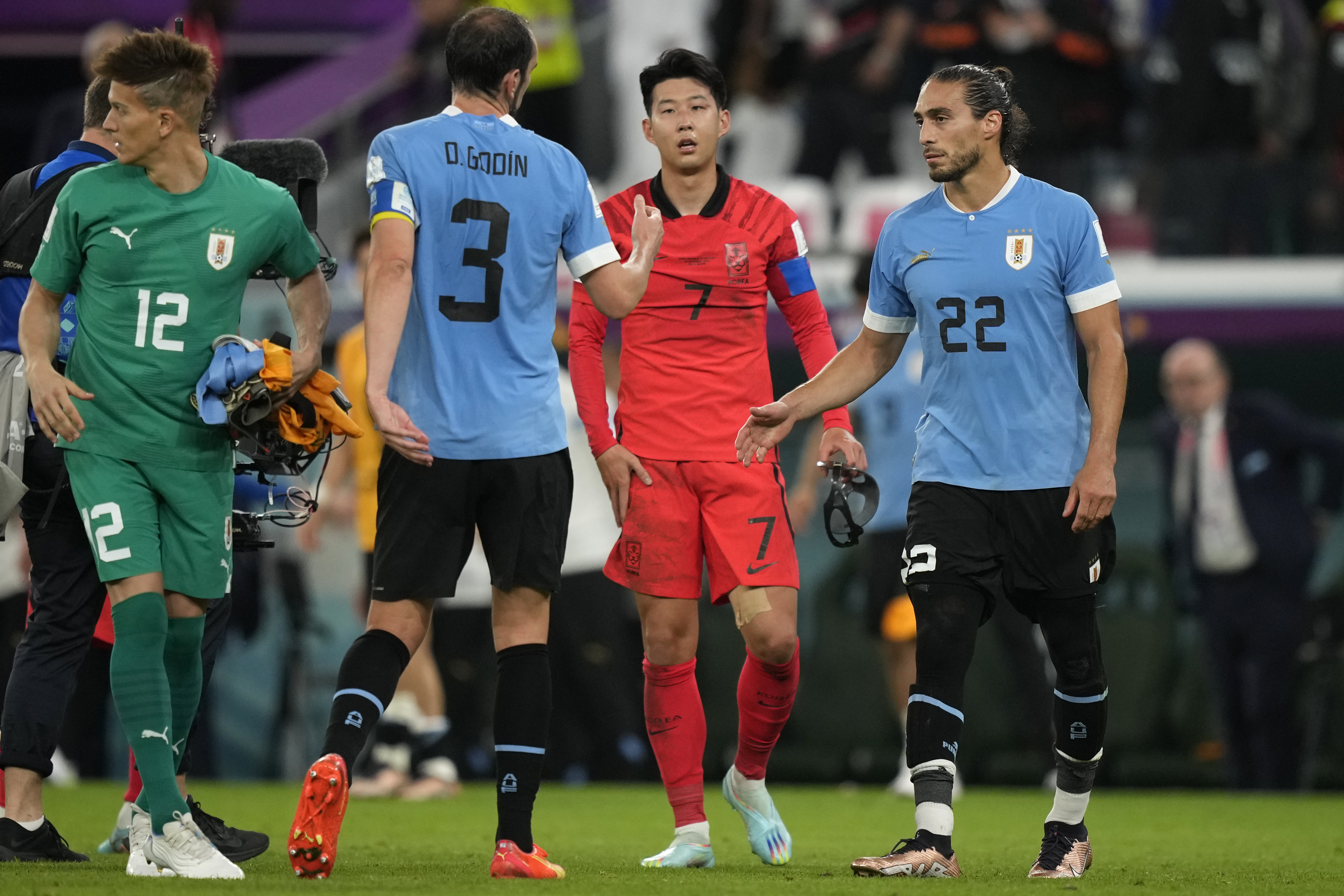South Korea's Son Heung-min, second right, walks to greet Uruguay players at the end of the World Cup group H soccer match between Uruguay and South Korea, at the Education City Stadium in Al Rayyan , Qatar, Thursday, Nov. 24, 2022. 