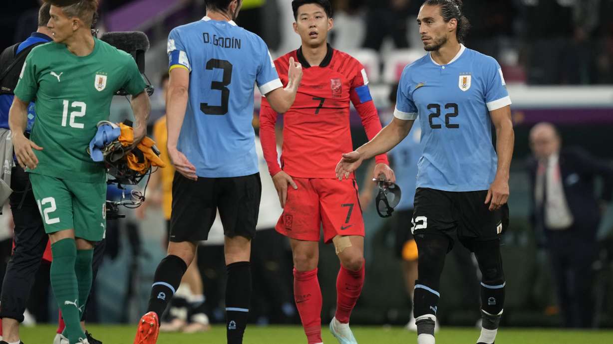 South Korea's Son Heung-min, second right, walks to greet Uruguay players at the end of the World Cup group H soccer match between Uruguay and South Korea, at the Education City Stadium in Al Rayyan , Qatar, Thursday, Nov. 24, 2022.