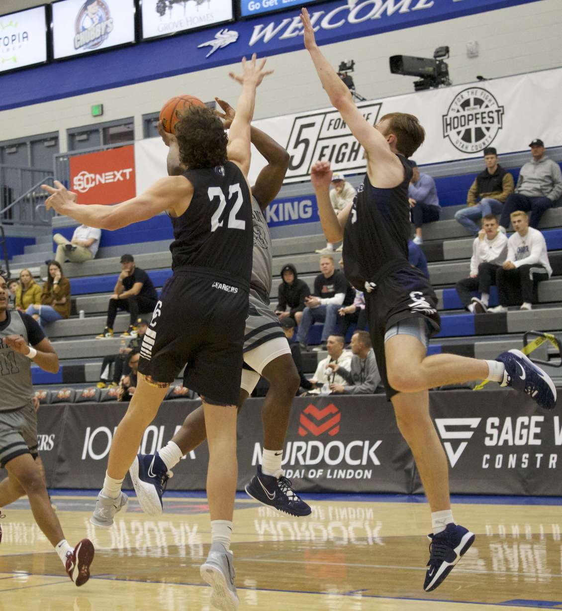 Corner Canyon's Sam Chandler (22) and Brady Kozlowsky block a shot during the Chargers' 88-63 win over Bisho Walsh (Md.) in the 5 For The Fight National Hoopfest of Utah County, Wednesday, Nov. 23, 2022 at Pleasant Grove High School.
