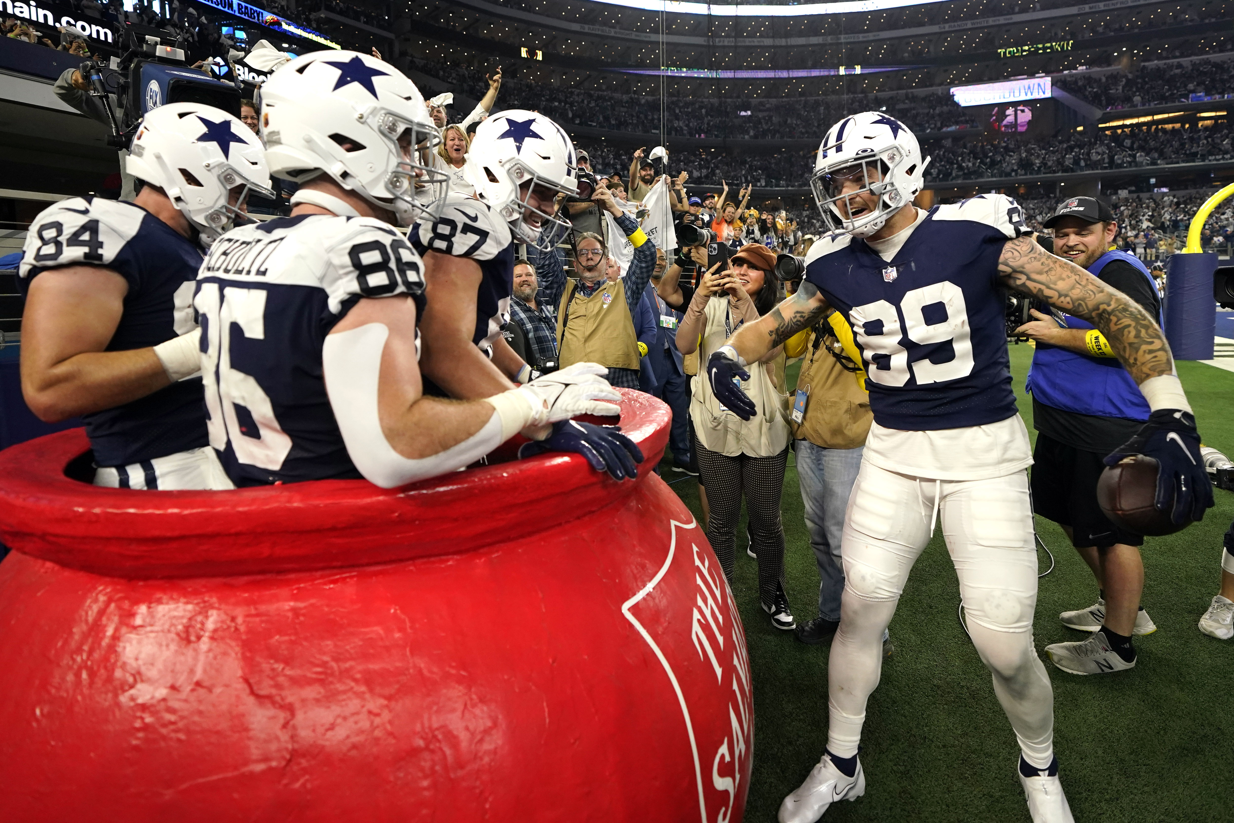 Dallas Cowboys tight end Peyton Hendershot (89) celebrates with Dalton Schultz (86), Sean McKeon (84) and Jake Ferguson (87) after scoring a touchdown against the New York Giants during the second half of an NFL football game Thursday, Nov. 24, 2022, in Arlington, Texas.