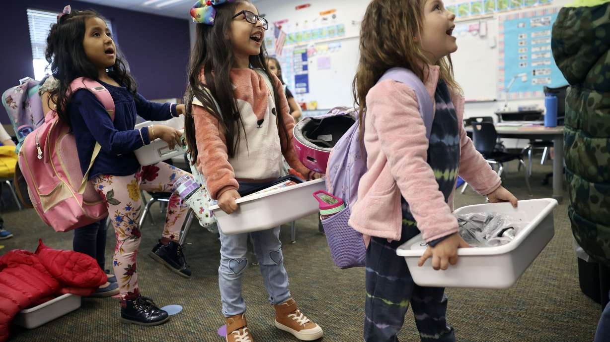 Kindergarteners Daleyza Plancarte Castro, left, Aitana De La Cruz and Alexis Bernal wait to change classrooms to spend the second half of the day in Spanish language immersion kindergarten at Daniels Canyon Elementary School in Heber City on March 29.