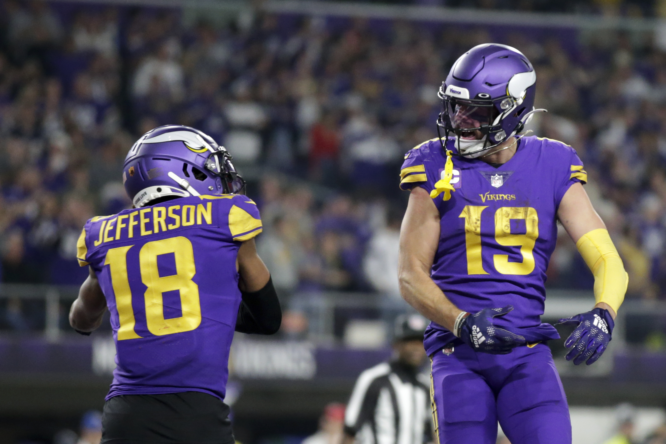 Minnesota Vikings wide receiver Adam Thielen (19) celebrates with teammate wide receiver Justin Jefferson (18) after catching a 15-yard touchdown pass during the second half of an NFL football game against the New England Patriots, Thursday, Nov. 24, 2022, in Minneapolis.