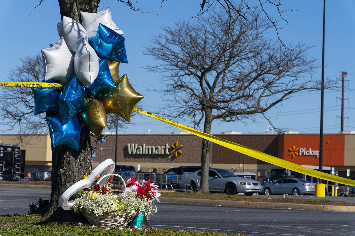 Flowers and balloons have been placed near the scene of a mass shooting at a Walmart, Wednesday, Nov. 23, in Chesapeake, Va. A Walmart manager opened fire on fellow employees in the break room of the Virginia store, killing several people in the country’s second high-profile mass shooting in four days, police and witnesses said Wednesday.