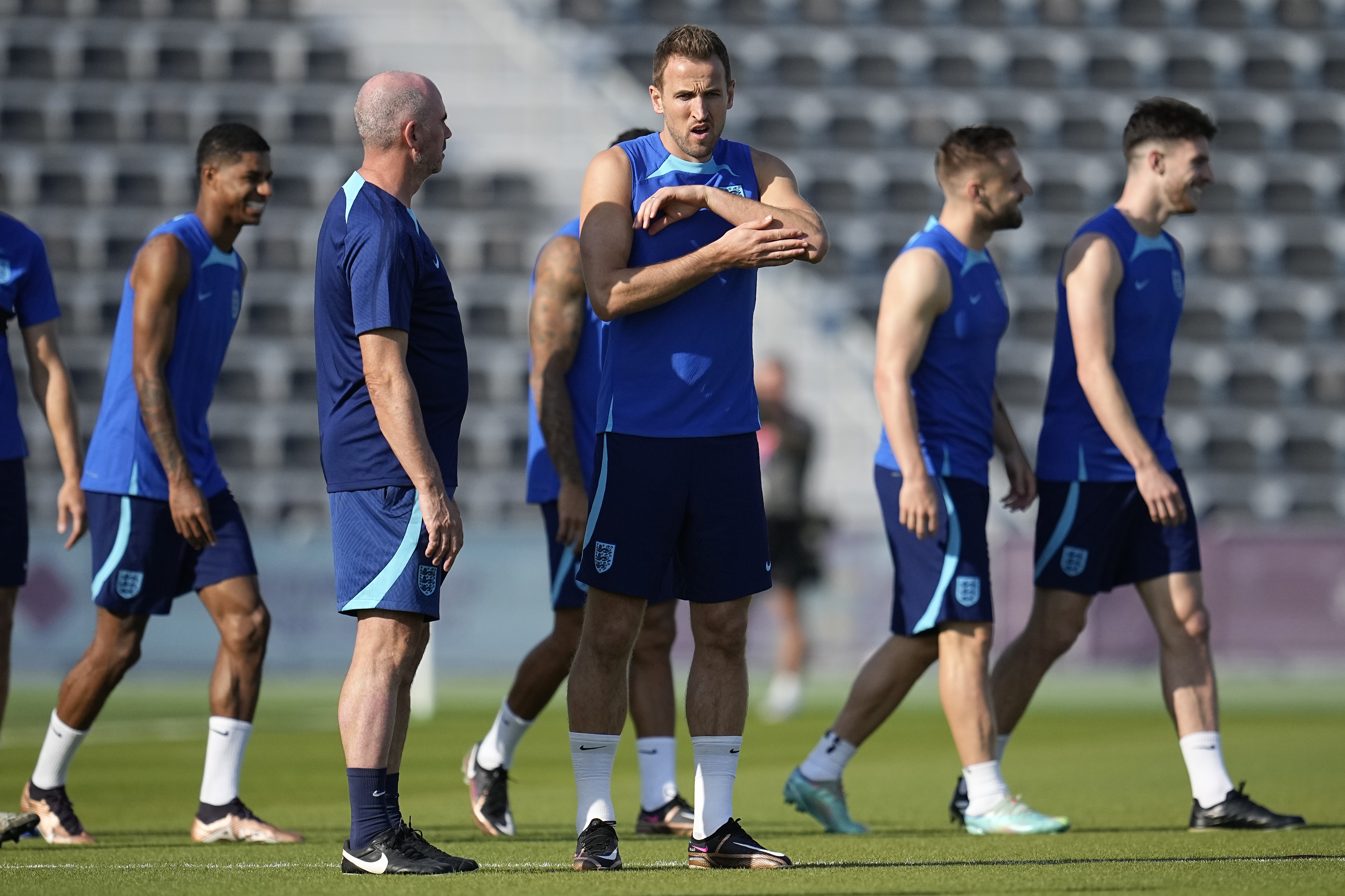 England's Harry Kane, middle, stands on the field during England's official training on the eve of the group B World Cup soccer match between England and the United States, at Al Wakrah Sports Complex, in Al Wakrah, Qatar, Thursday, Nov. 24, 2022. 