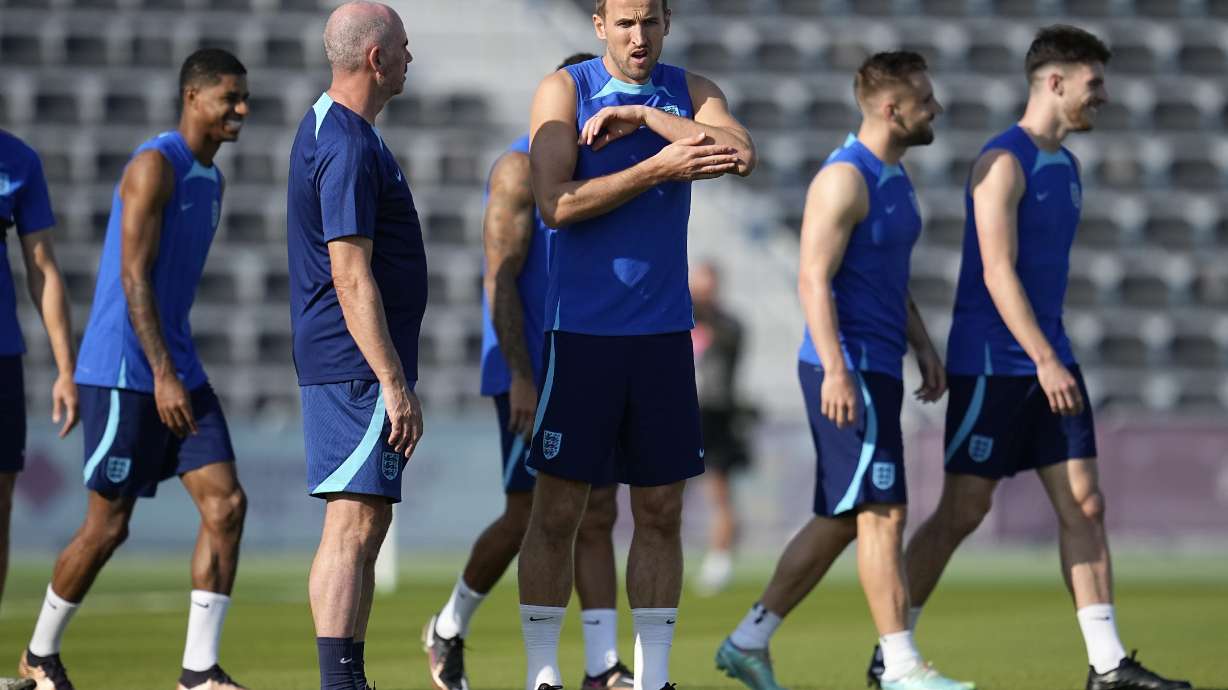 England's Harry Kane, middle, stands on the field during England's official training on the eve of the group B World Cup soccer match between England and the United States, at Al Wakrah Sports Complex, in Al Wakrah, Qatar, Thursday, Nov. 24, 2022.