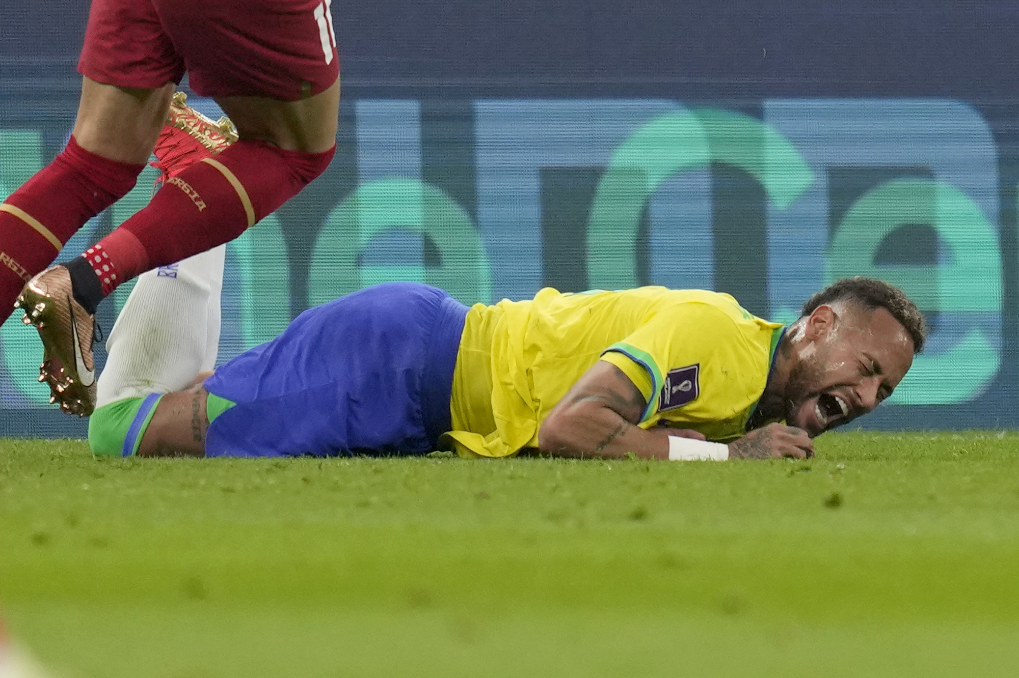 Brazil's Neymar grimaces as he falls to the ground during the World Cup group G soccer match between Brazil and Serbia, at the Lusail Stadium in Lusail, Qatar, Thursday, Nov. 24, 2022. 