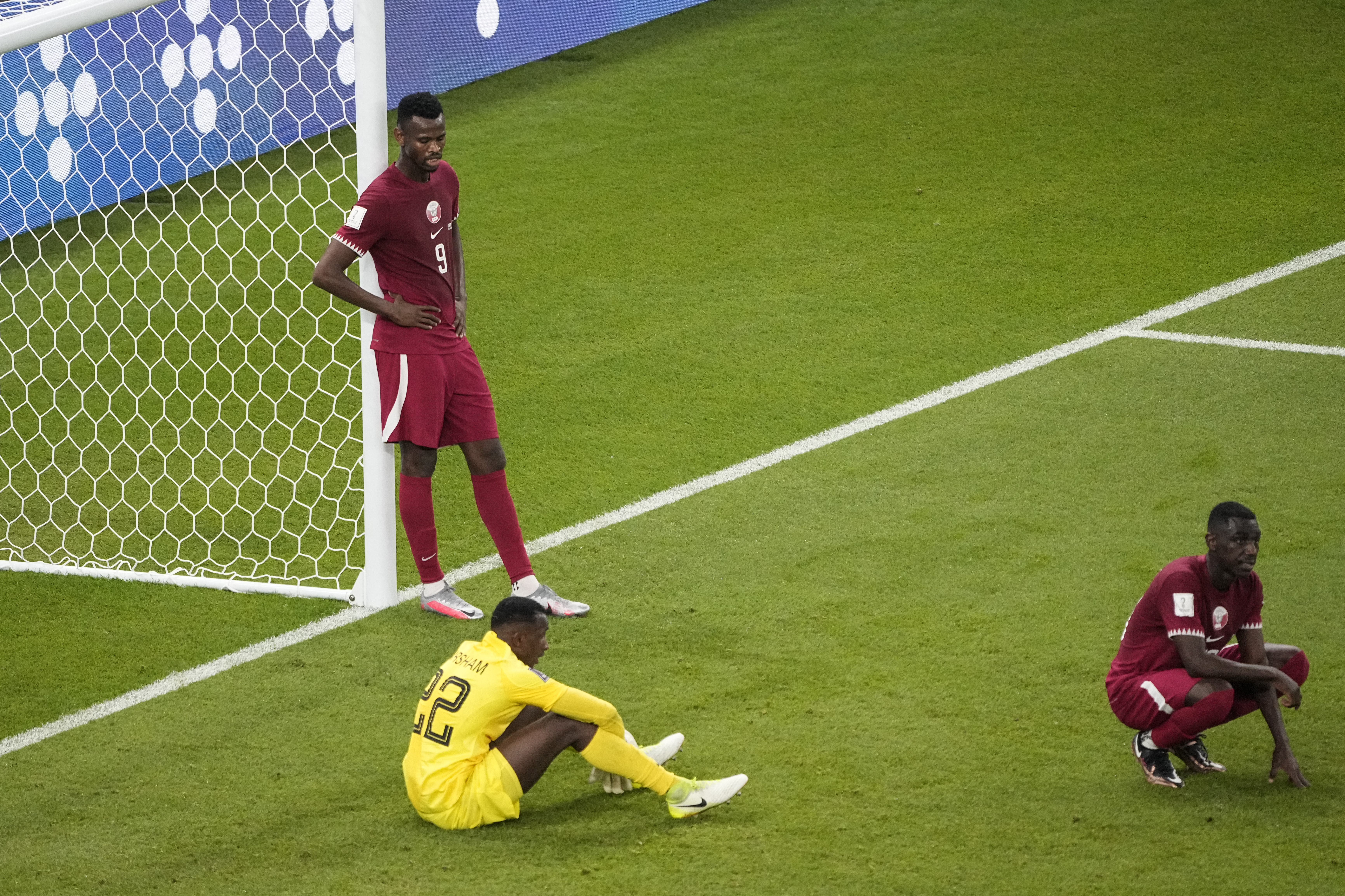 Qatar's Mohammed Muntari, left, and Qatar's goalkeeper Meshaal Barsham look on after the World Cup group A soccer match between Qatar and Senegal, at the Al Thumama Stadium in Doha, Qatar, Friday, Nov. 25, 2022. Senegal won 3-1. 
