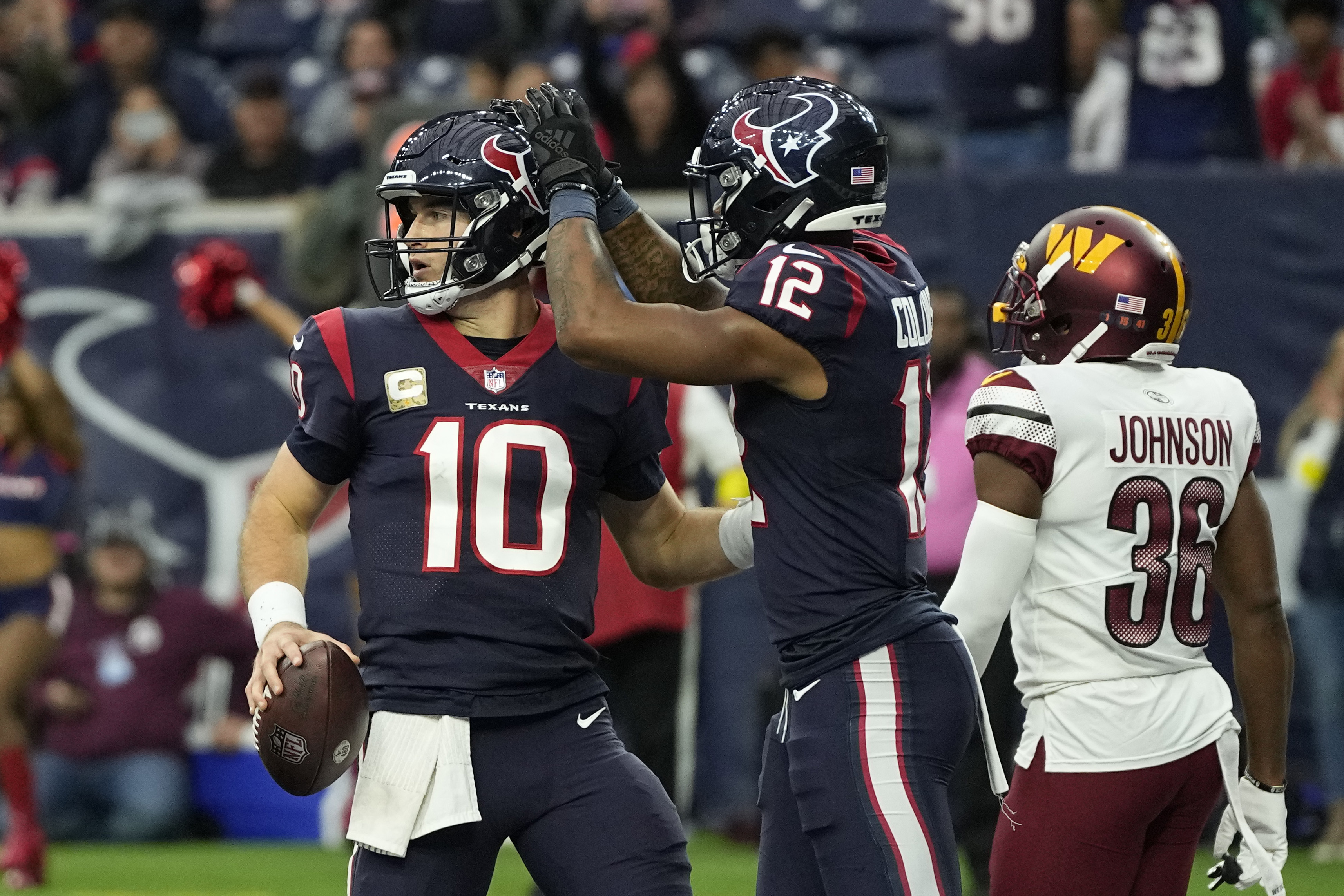 Houston Texans quarterback Davis Mills (10) celebrates his touchdown run with teamamte Nico Collins (12) during the second half of an NFL football game Sunday, Nov. 20, 2022, in Houston. 