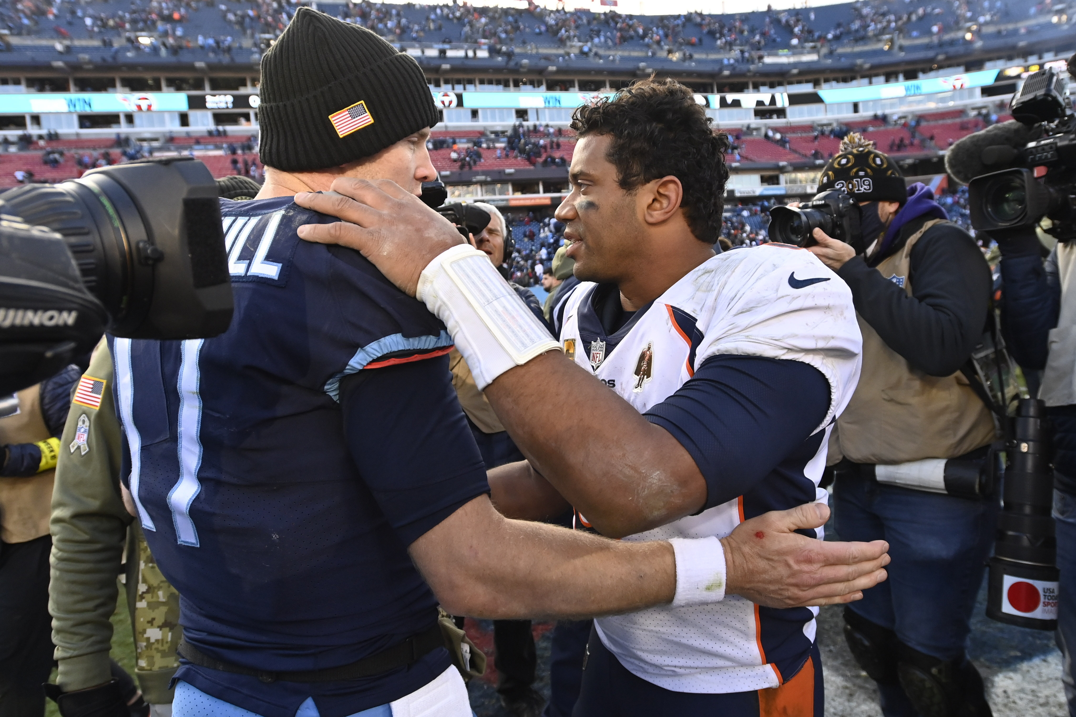 Tennessee Titans quarterback Ryan Tannehill speaks with Denver Broncos quarterback Russell Wilson after an NFL football game, Sunday, Nov. 13, 2022, in Nashville, Tenn. The Tennessee Titans won 17-10.