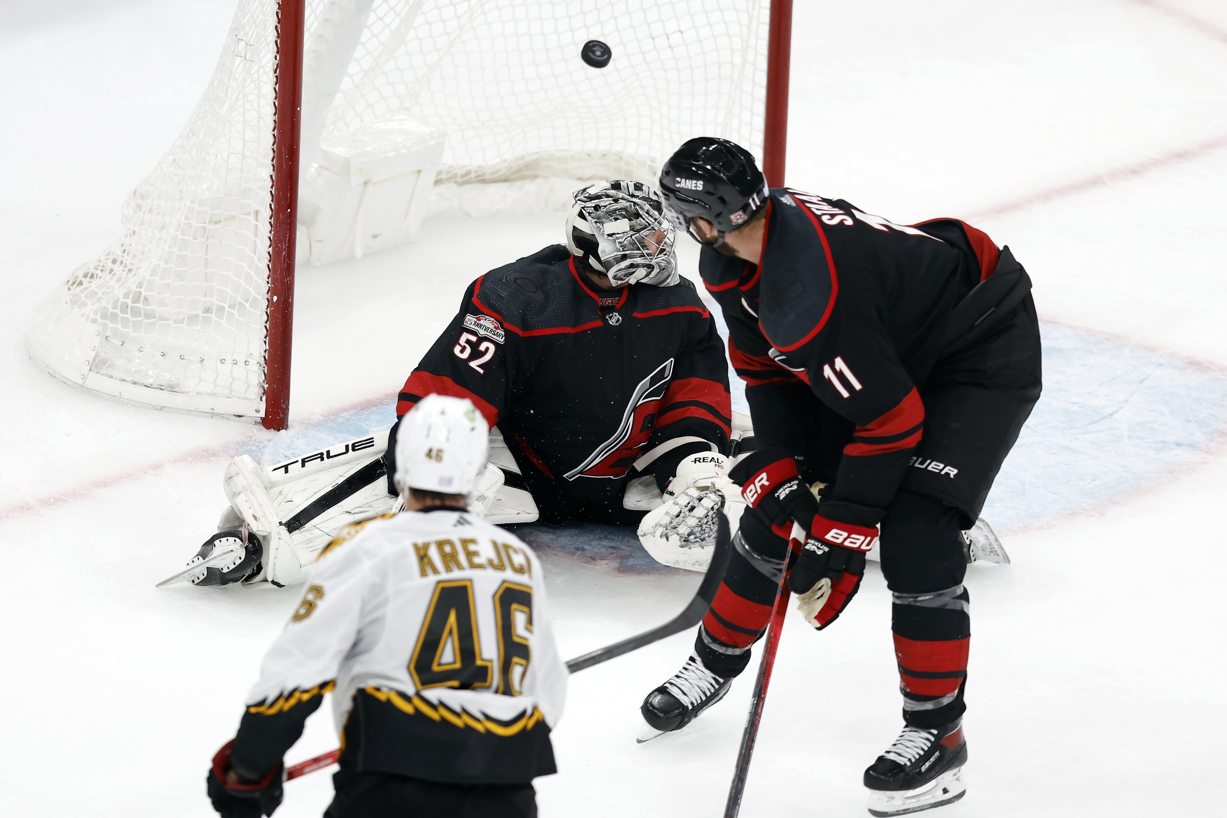 Boston Bruins' David Krejci (46) scores on Carolina Hurricanes' Pyotr Kochetkov (52) during the second period of an NHL hockey game, Friday, Nov. 25, 2022, in Boston. 