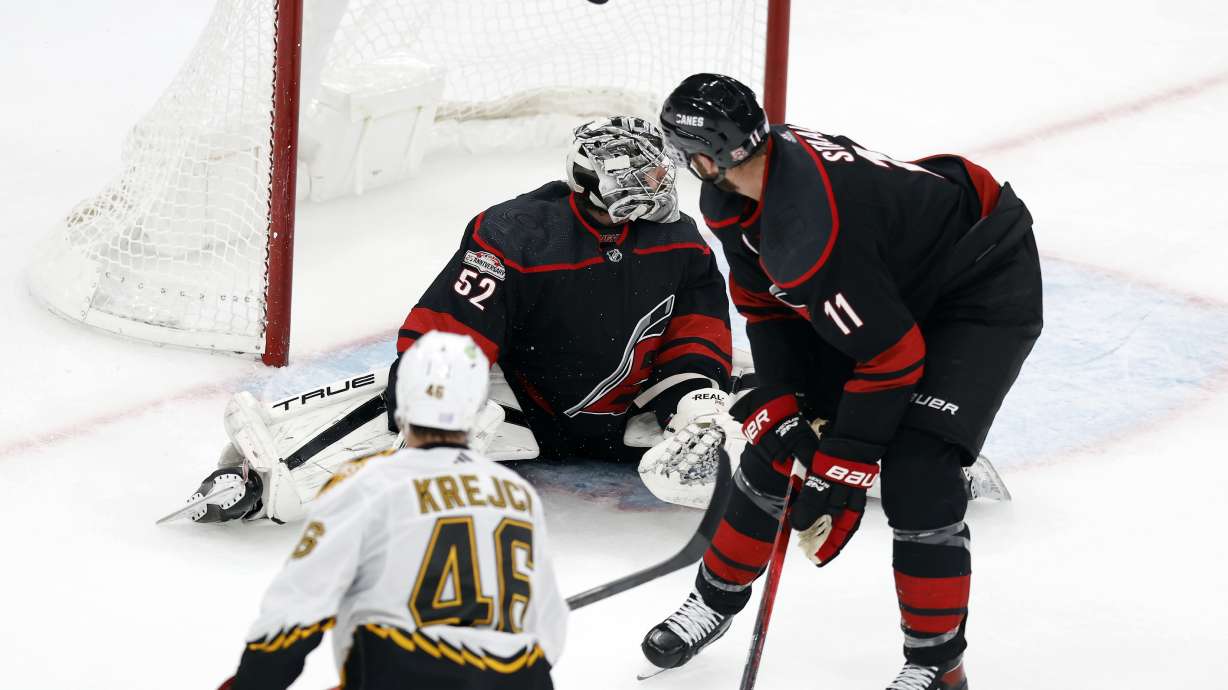 Boston Bruins' David Krejci (46) scores on Carolina Hurricanes' Pyotr Kochetkov (52) during the second period of an NHL hockey game, Friday, Nov. 25, 2022, in Boston.