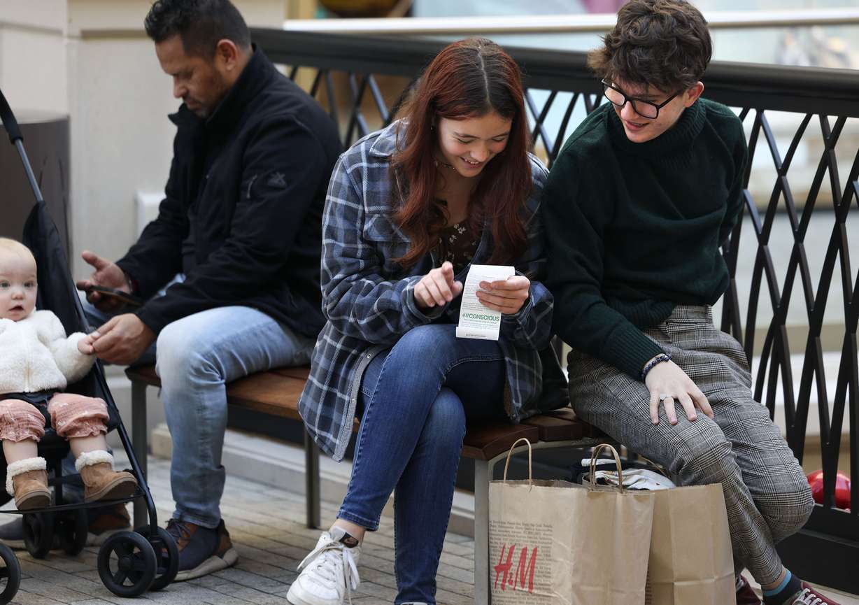 Abbie Webster and Sean Hammond look over Webster's receipt after shopping bargains at H&M at the City Creek Center in Salt Lake City on Black Friday.