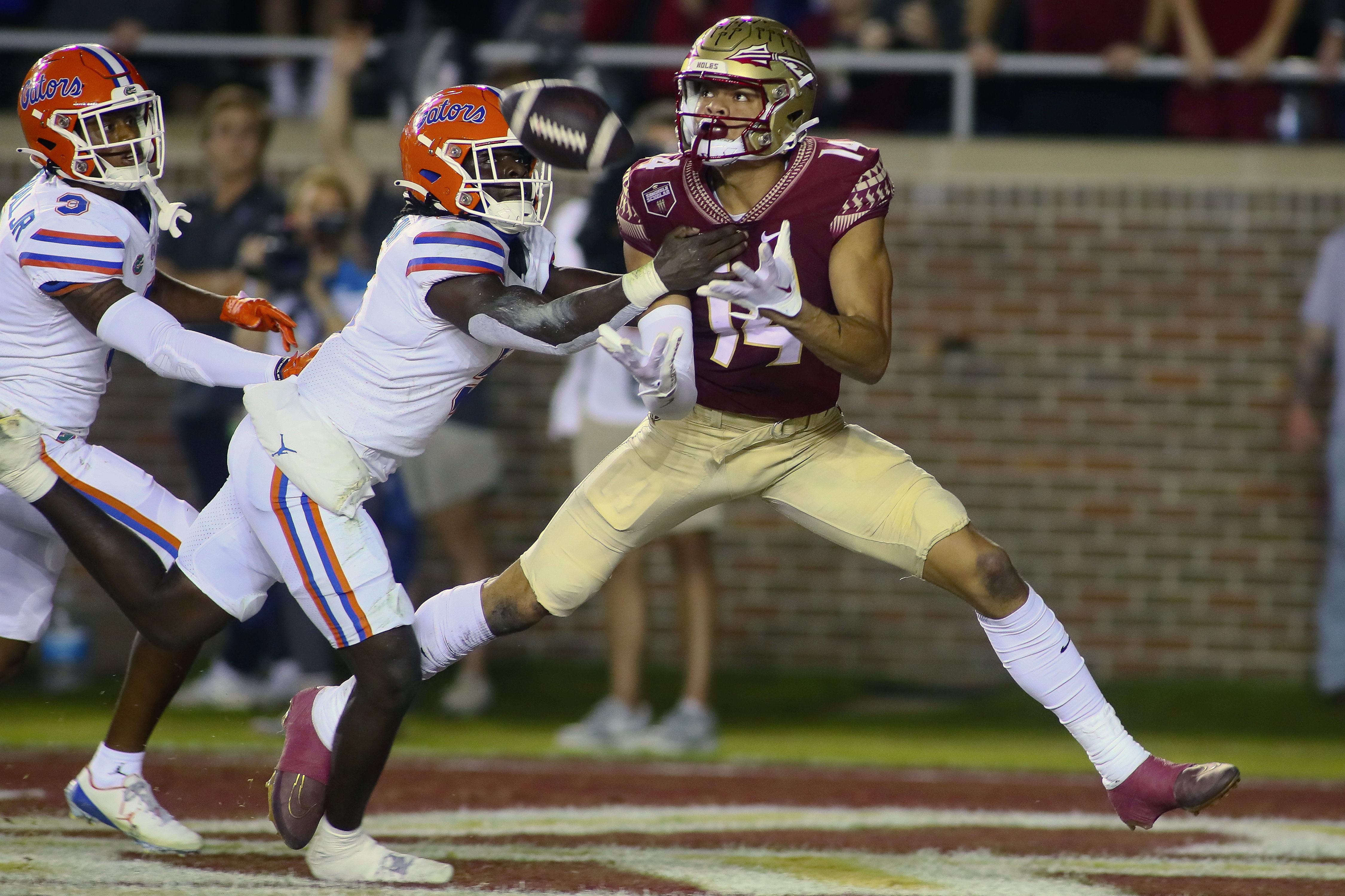 Florida State wide receiver Johnny Wilson (14) is unable to hold onto a pass in the end zone as Florida safety Kamari Wilson (5) defends in the first quarter of an NCAA college football game, Friday, Nov. 25, 2022, in Tallahassee, Fla. 
