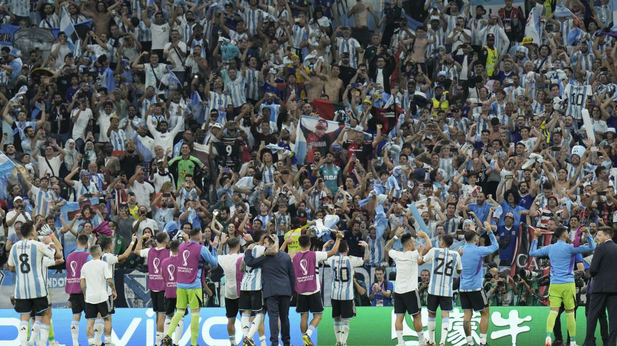 Argentinian players acknowledge fans after winning the World Cup group C soccer match between Argentina and Mexico, at the Lusail Stadium in Lusail, Qatar, Saturday, Nov. 26, 2022.
