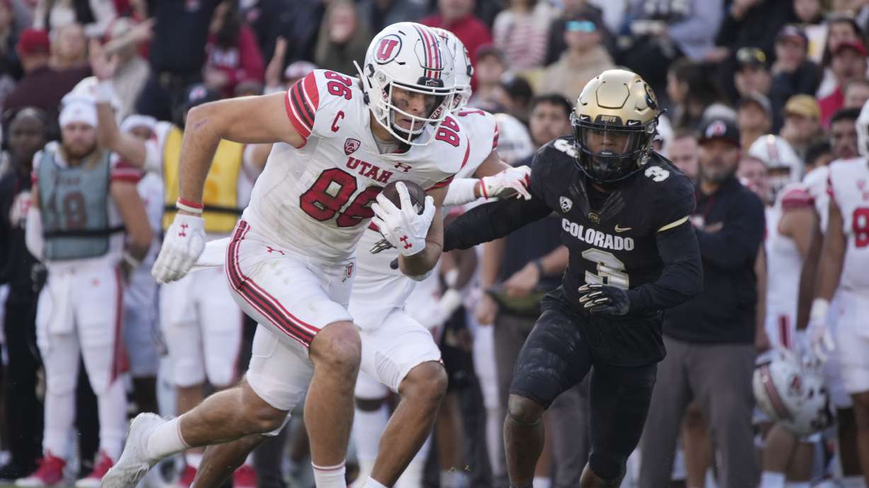 Utah tight end Dalton Kincaid, left, runs after catching a pass as Colorado safety Jeremy Mack Jr. (3) pursues in the first half of an NCAA college football game Saturday, Nov. 26, 2022, in Boulder, Colo.
