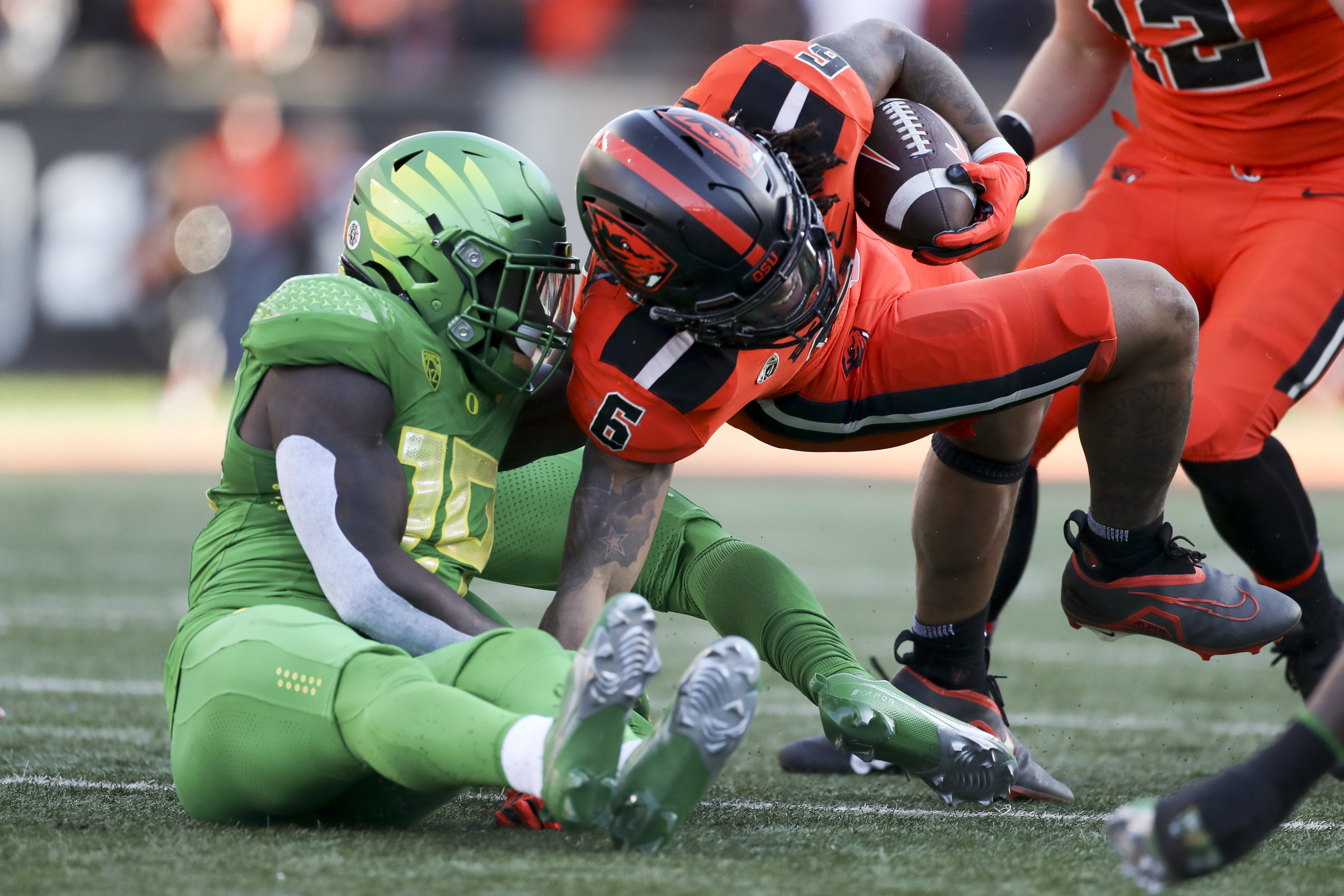 Oregon State running back Damien Martinez (6) is brought down by Oregon defensive back Jamal Hill (19) during the first half of an NCAA college football game on Saturday, Nov 26, 2022, in Corvallis, Ore.