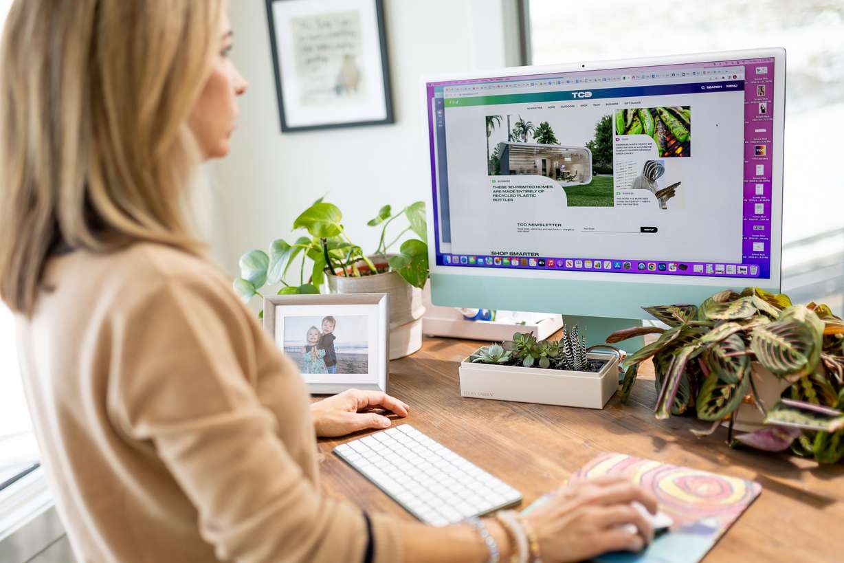 Anna Robertson, co-founder of The Cool Down, shows off the website while posing for a photo at her home in Park City on Thursday. The Cool Down is described by its founders as the first mainstream climate brand on a mission to connect a wide-ranging audience to climate topics and conversations.