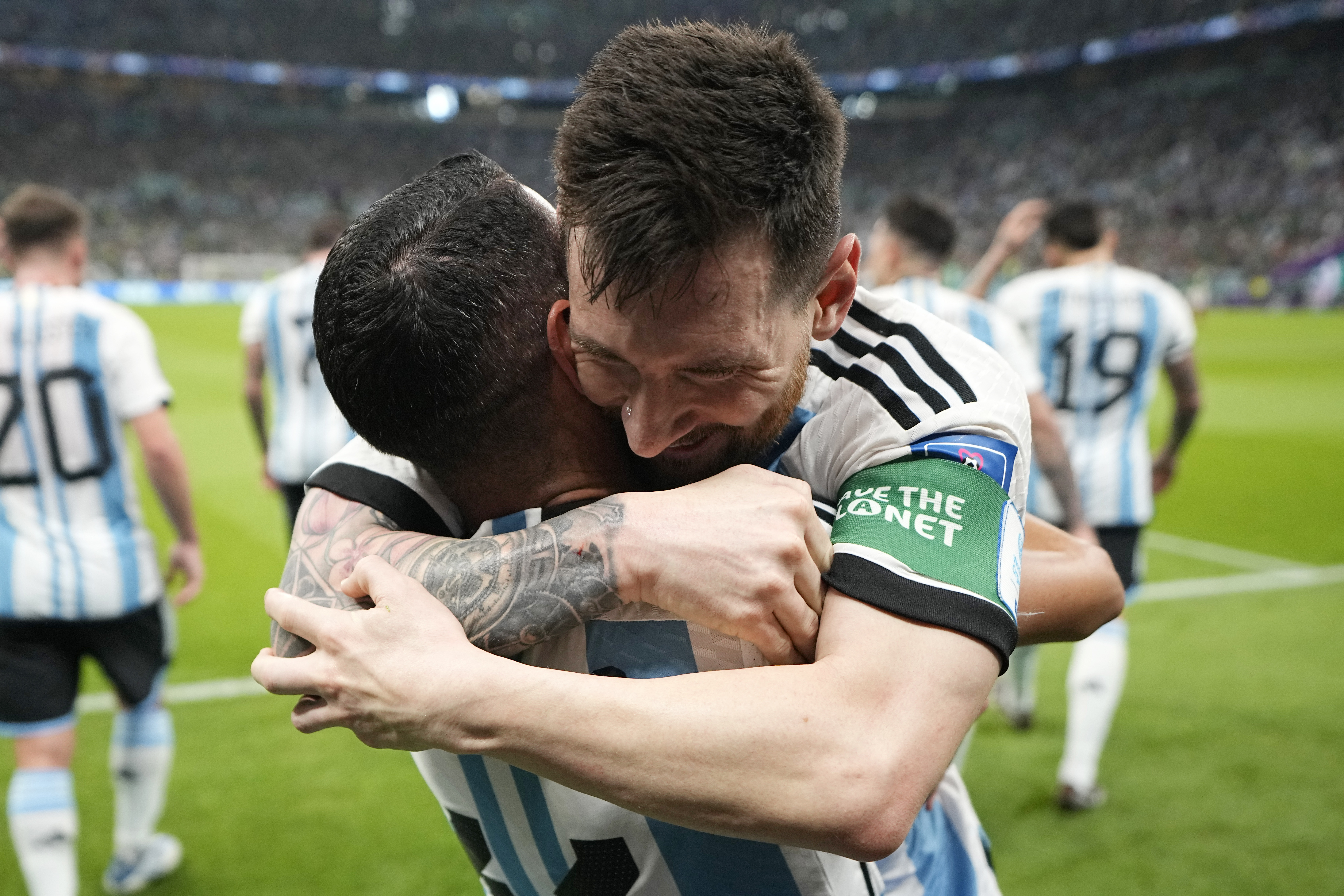 Argentina's Lionel Messi, right, celebrates with his teammate Angel Di Maria after scoring his side's opening goal during the World Cup group C soccer match between Argentina and Mexico, at the Lusail Stadium in Lusail, Qatar, Saturday, Nov. 26, 2022. 