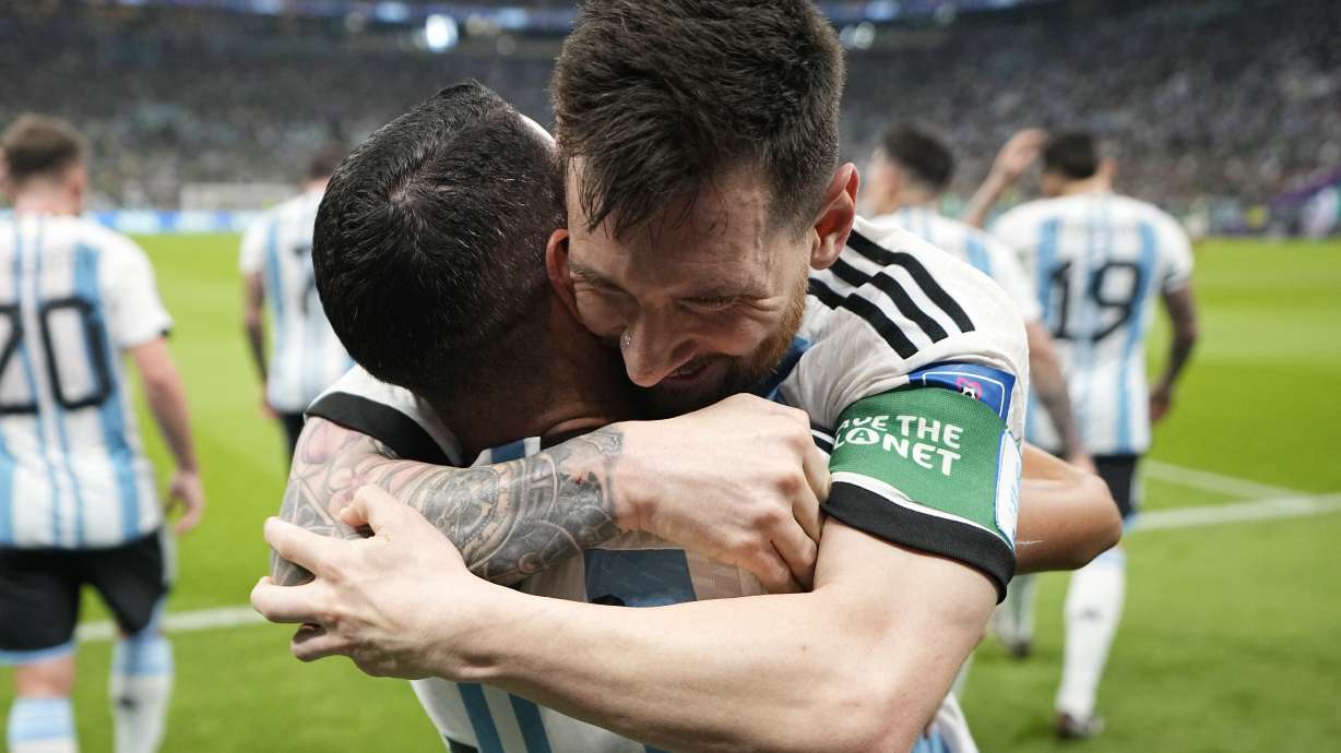 Argentina's Lionel Messi, right, celebrates with his teammate Angel Di Maria after scoring his side's opening goal during the World Cup group C soccer match between Argentina and Mexico, at the Lusail Stadium in Lusail, Qatar, Saturday, Nov. 26, 2022.