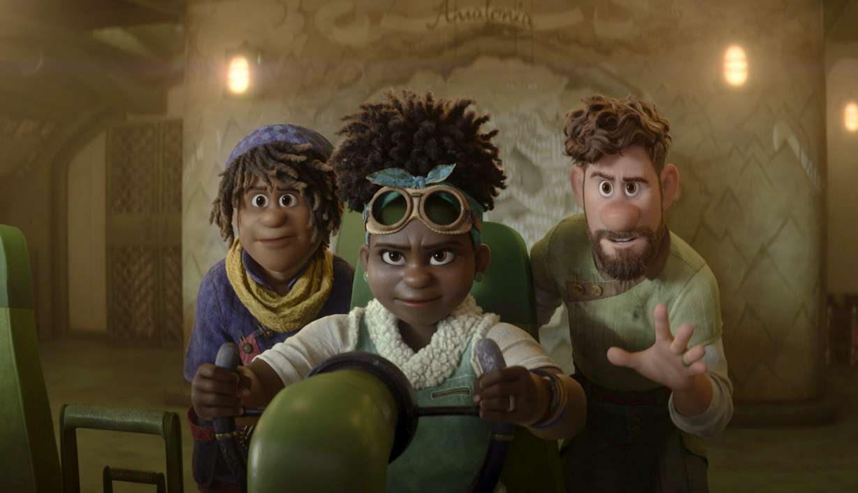This image released by Disney shows Ethan Clade, voiced by Jaboukie Young-White, left, Meridian Clade, voiced by Gabrielle Union, center, and Searcher Clade, voiced by Jake Gyllenhaal, in a scene from the animated film "Strange World."