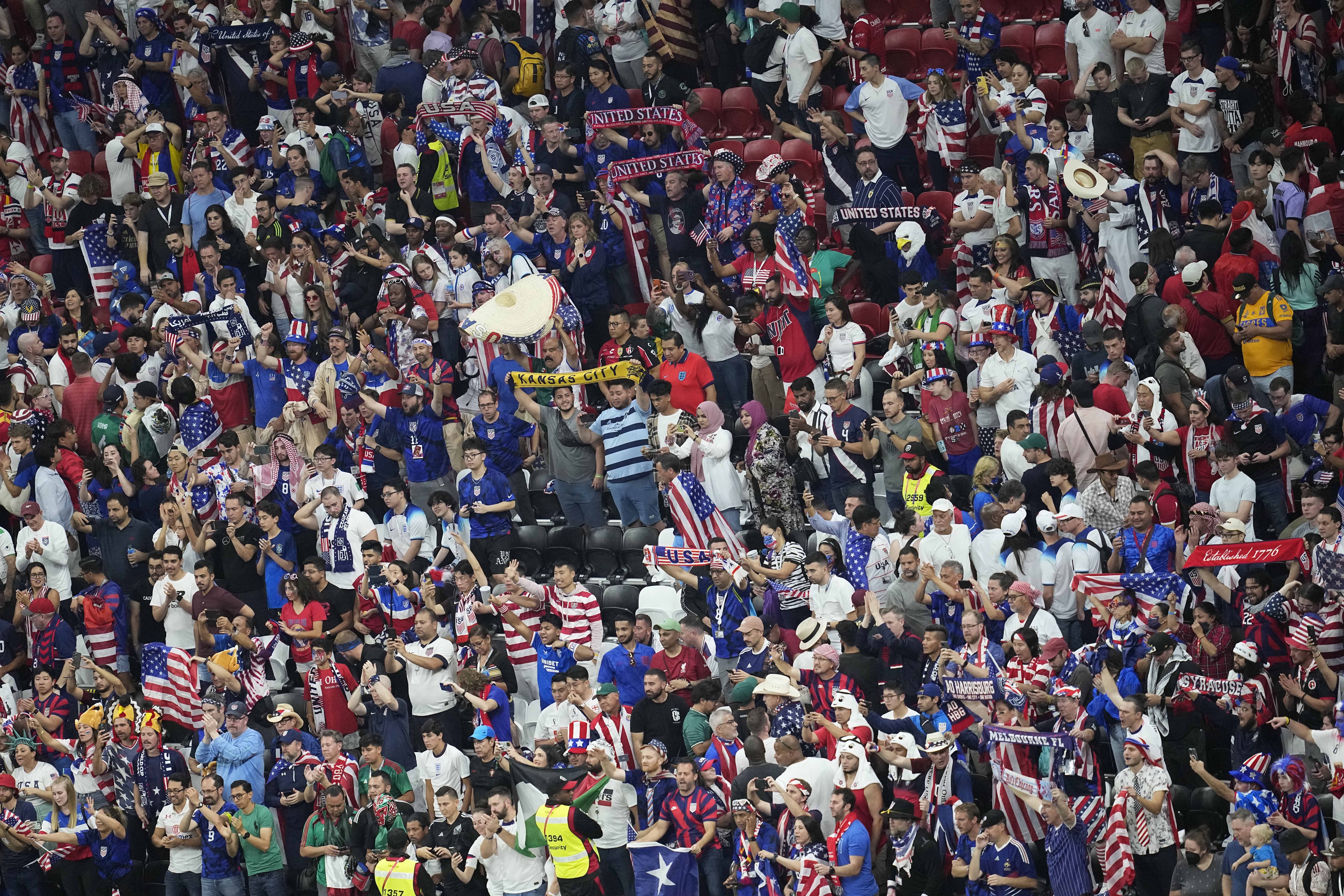 Fans from the United States cheer for their team during the World Cup group B soccer match between England and The United States, at the Al Bayt Stadium in Al Khor, Qatar, Friday, Nov. 25, 2022. 
