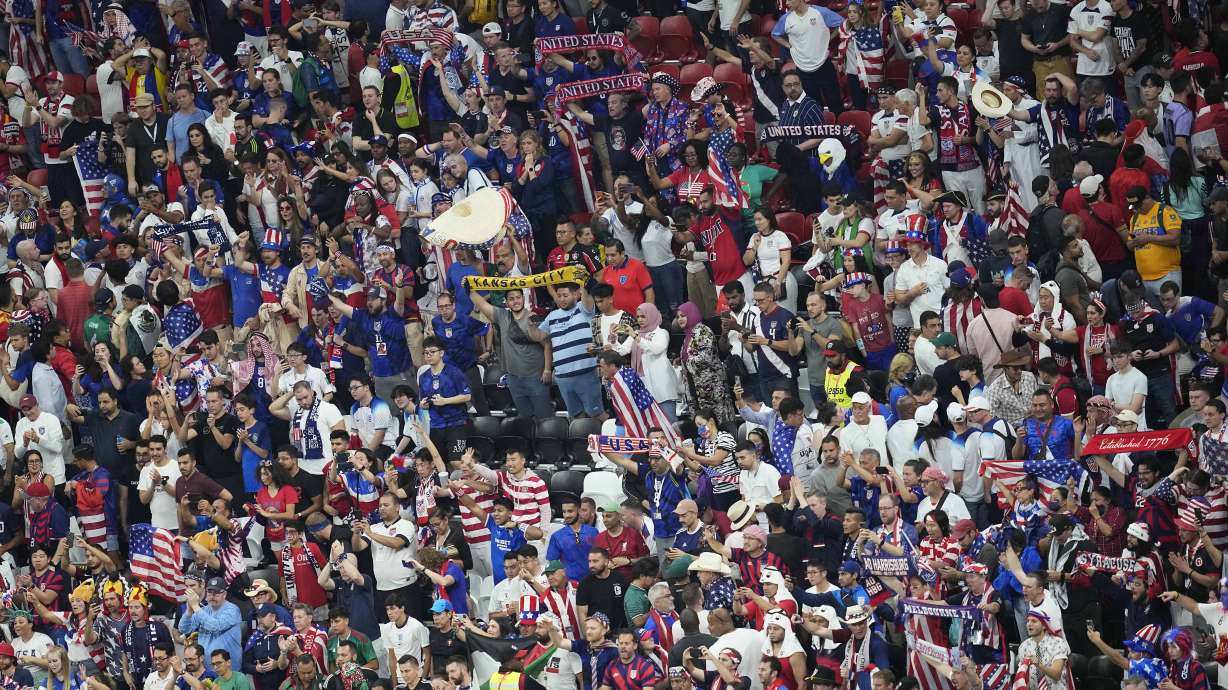 Fans from the United States cheer for their team during the World Cup group B soccer match between England and The United States, at the Al Bayt Stadium in Al Khor, Qatar, Friday, Nov. 25, 2022.
