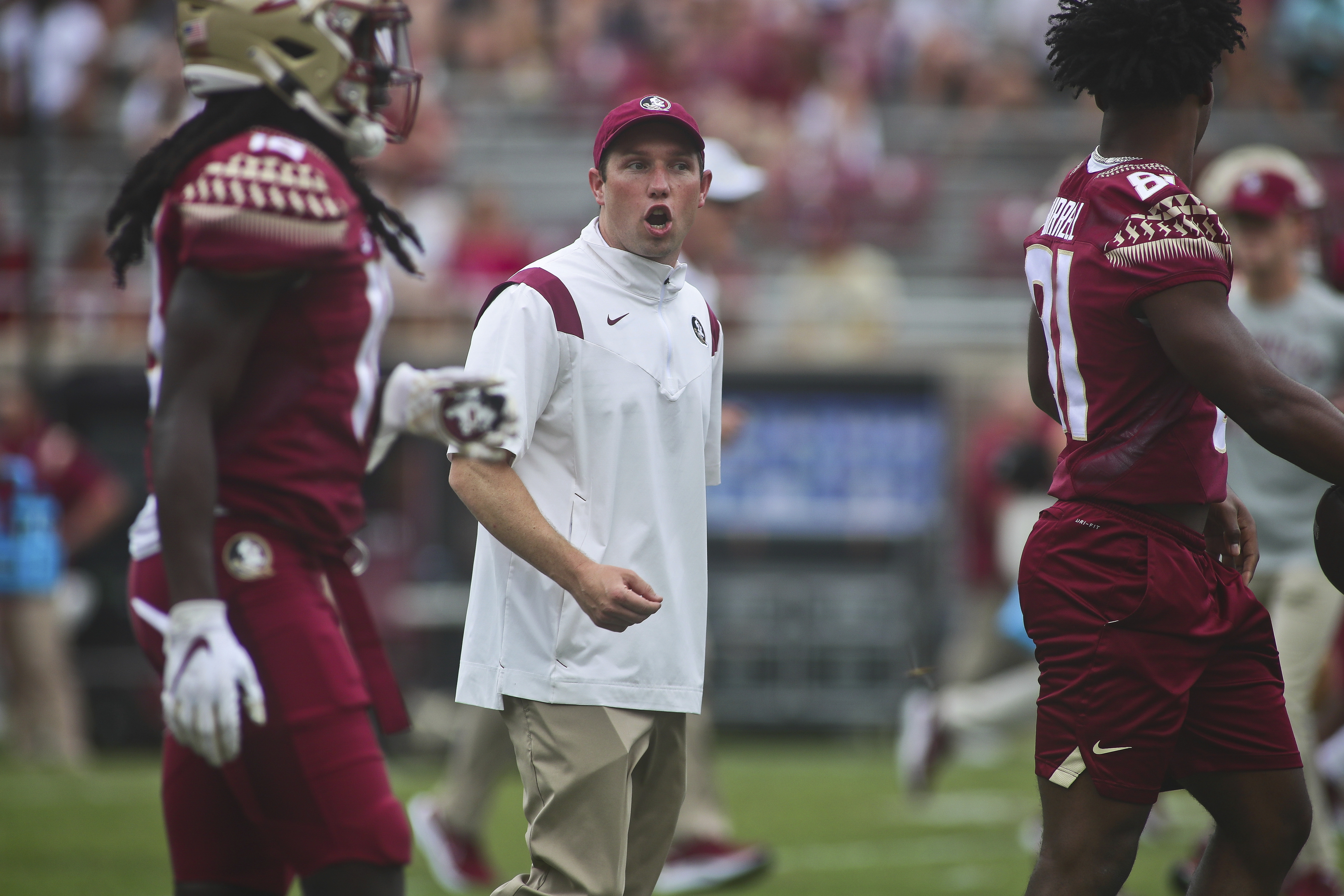FILE - Then-Florida State offensive coordinator/quarterbacks coach Kenny Dillingham talks to players before the start of an NCAA college football game against Syracuse on Oct. 2, 2021, in Tallahassee, Fla. Arizona State hired Oregon offensive coordinator Kenny Dillingham on Sunday, Nov. 27, 2022, making the 32-year-old the youngest head football coach in a Power Five conference. 