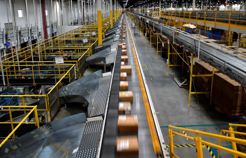 A fast-moving conveyor moves packages to delivery trucks during operations on Cyber Monday at Amazon's fulfillment center in Robbinsville, N.J., Nov. 29, 2021. Spending on Cyber Monday, the biggest U.S. online shopping day, is set to hit a record $11.2 billion.
