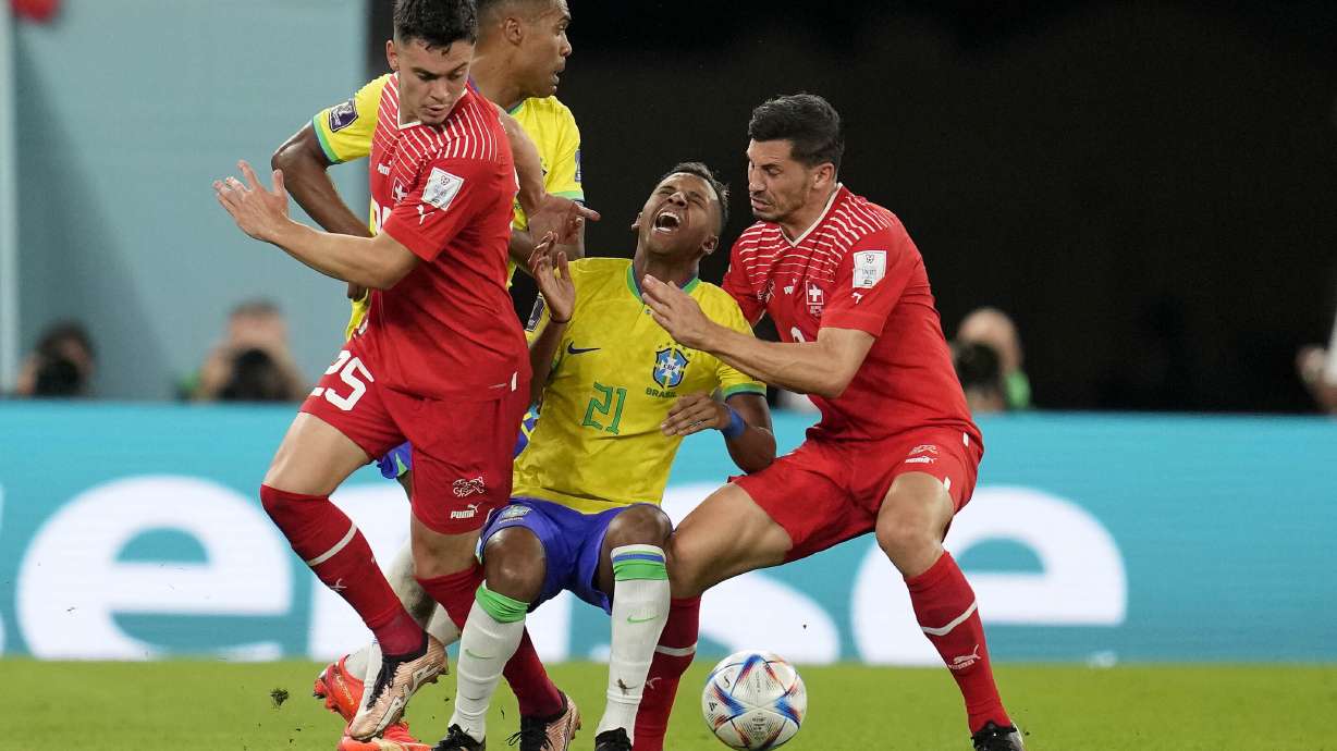 Switzerland's Fabian Rieder, left, and Switzerland's Remo Freuler challenge Brazil's Rodrygo during the World Cup group G soccer match between Brazil and Switzerland, at the Stadium 974 in Doha, Qatar, Monday, Nov. 28, 2022.