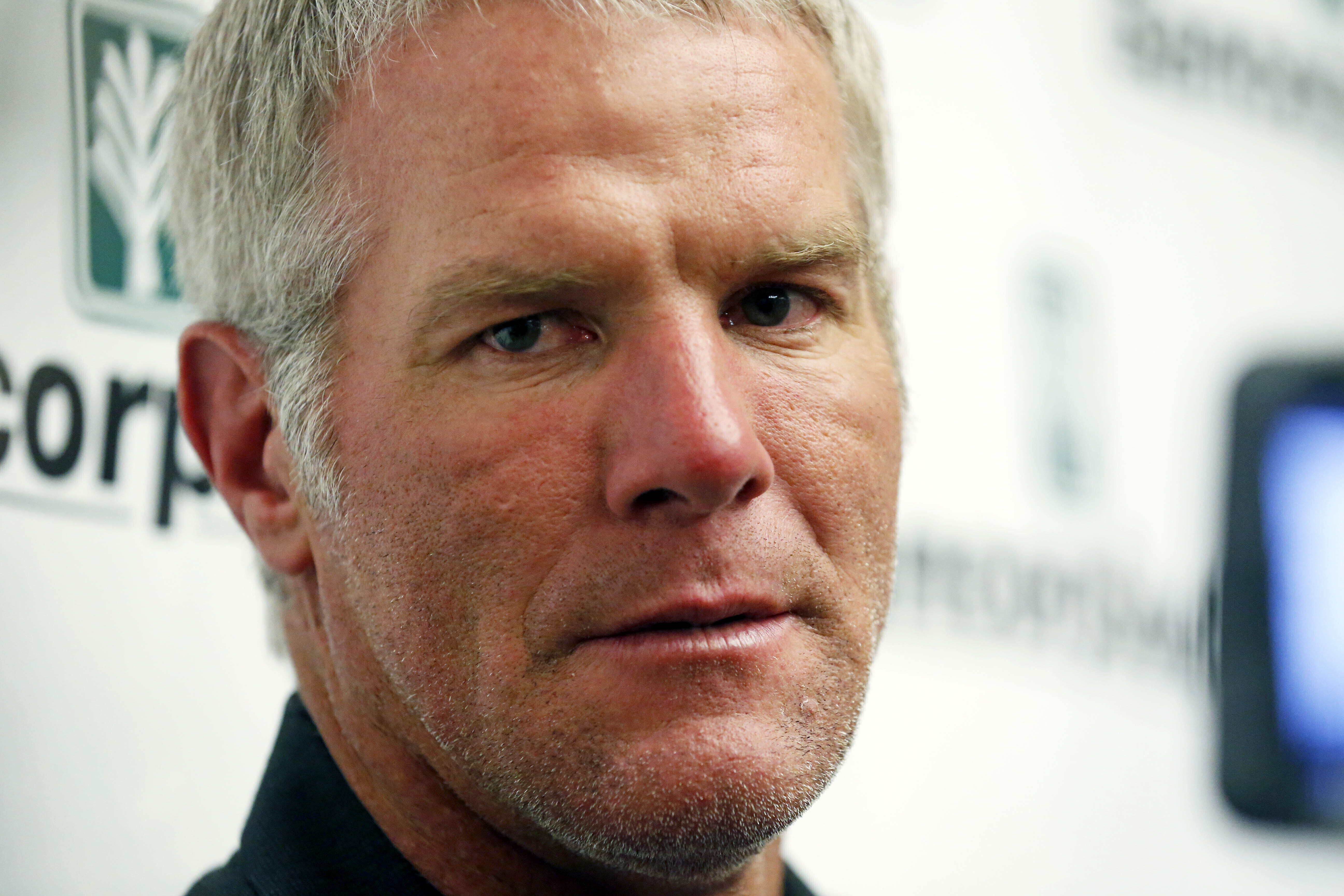 FILE - Former NFL football quarterback Brett Favre speaks with reporters prior to his induction to the Mississippi Hall of Fame in Jackson, Miss., on Aug. 1, 2015. Favre is asking to be removed from a civil lawsuit in Mississippi that seeks to recover millions of dollars in misspent welfare money that was intended to help some of the poorest people in the U.S. 