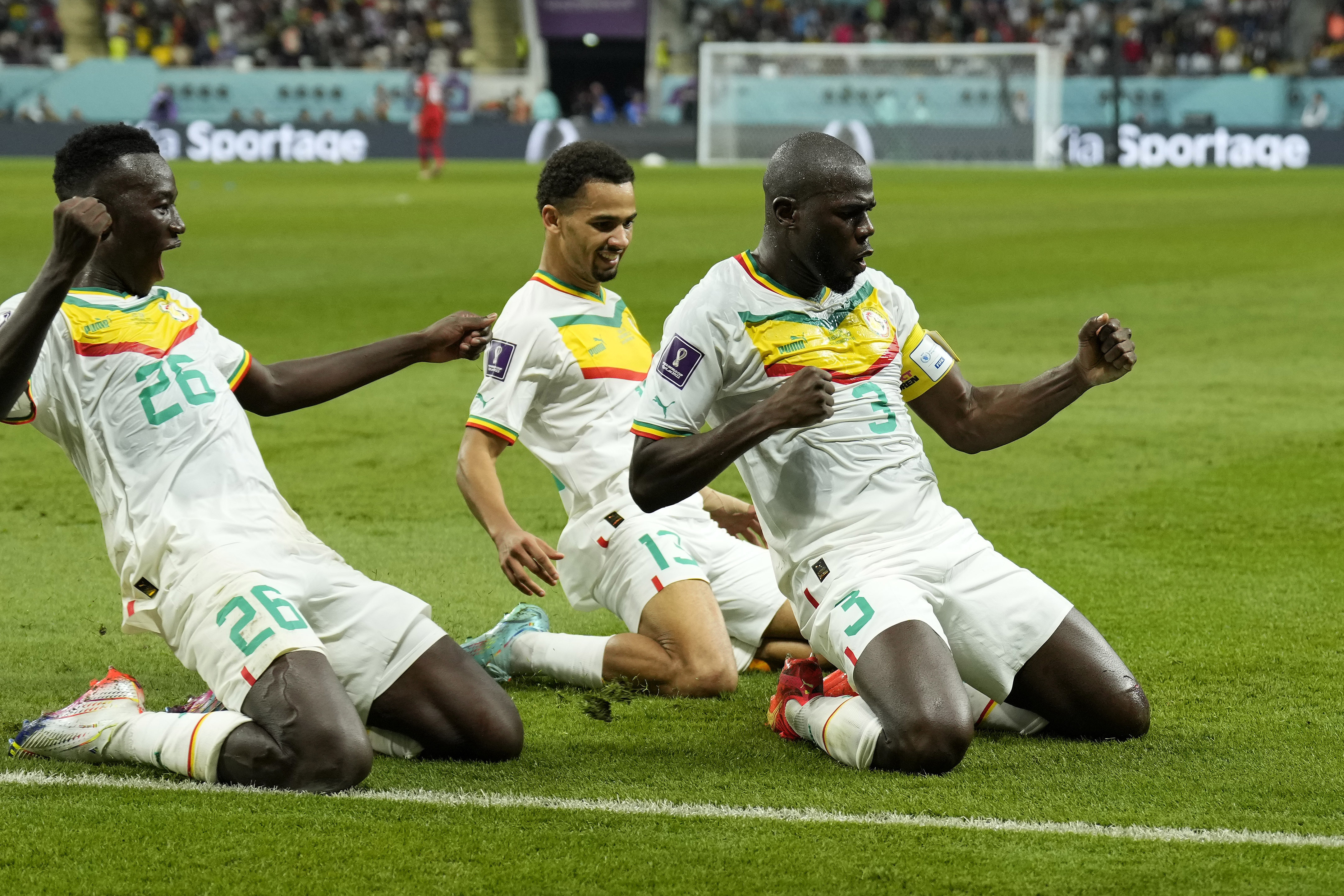 Senegal's Kalidou Koulibaly, right, celebrates with teammates scoring his side's second goal during the World Cup group A soccer match between Ecuador and Senegal, at the Khalifa International Stadium in Doha, Qatar, Tuesday, Nov. 29, 2022. 