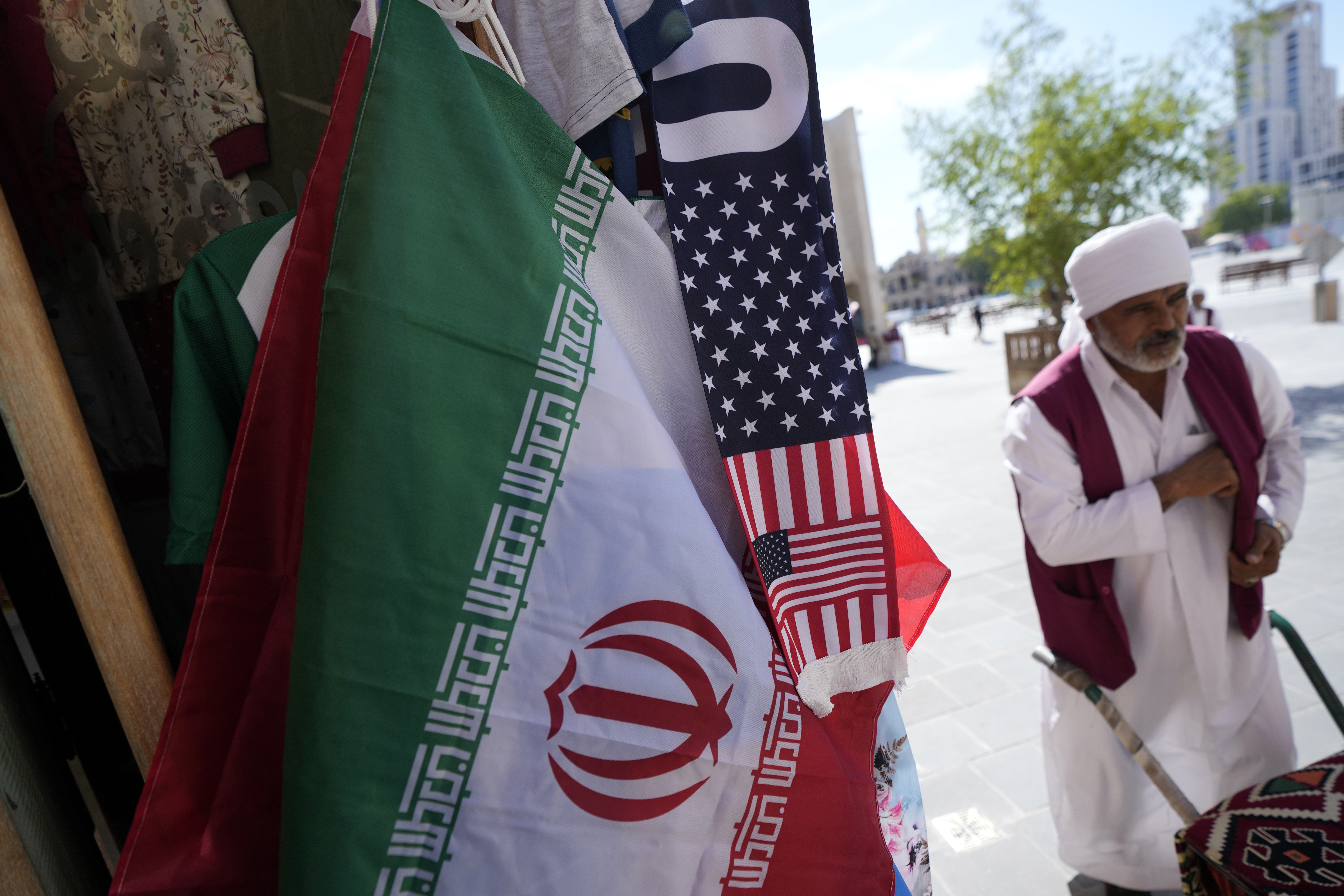An Iranian flag and a scarf depicting U.S. flag are sold at the Souq Waqif Market in Doha, Qatar, Tuesday, Nov. 29, 2022. 